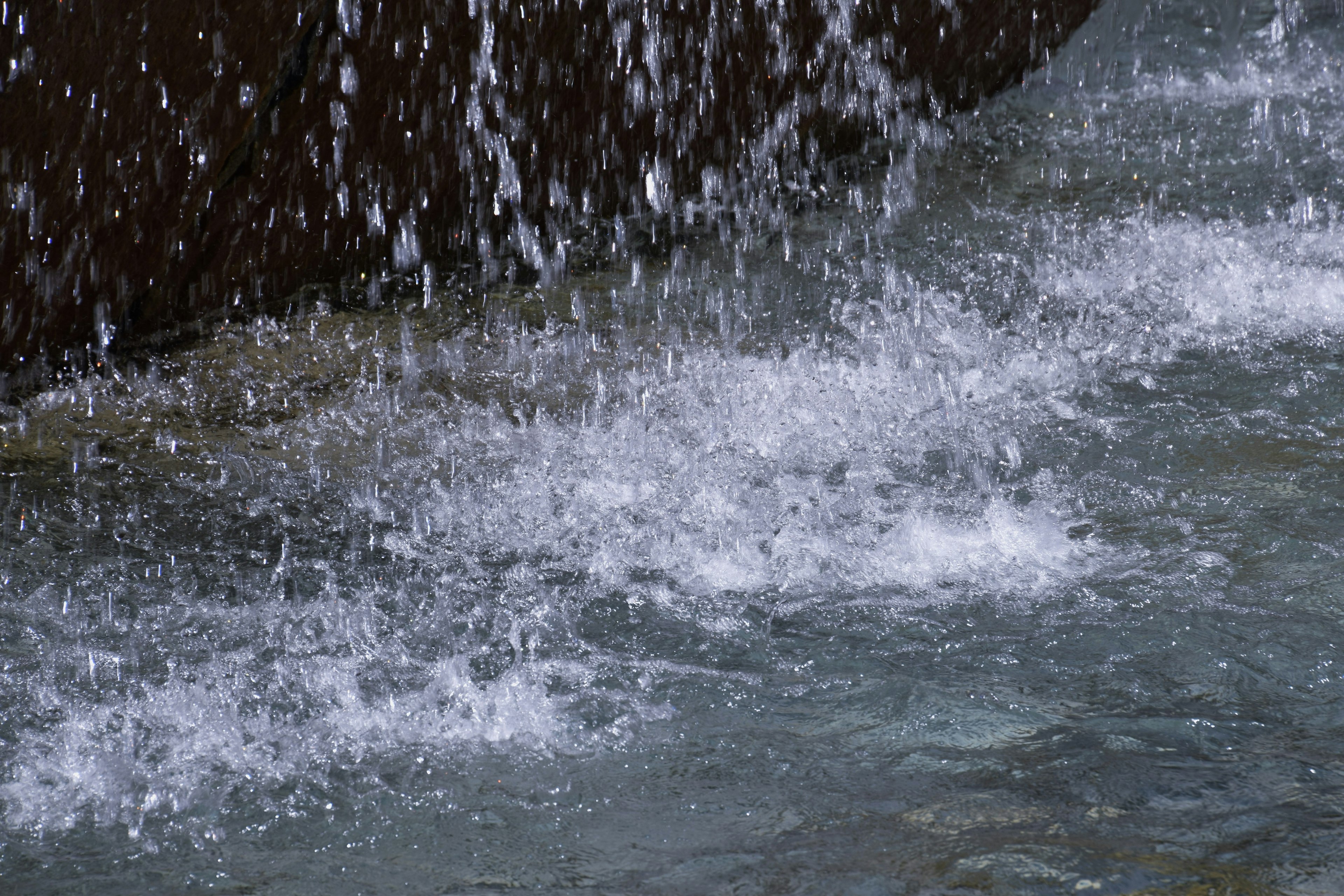 Water splashes against a rock surface