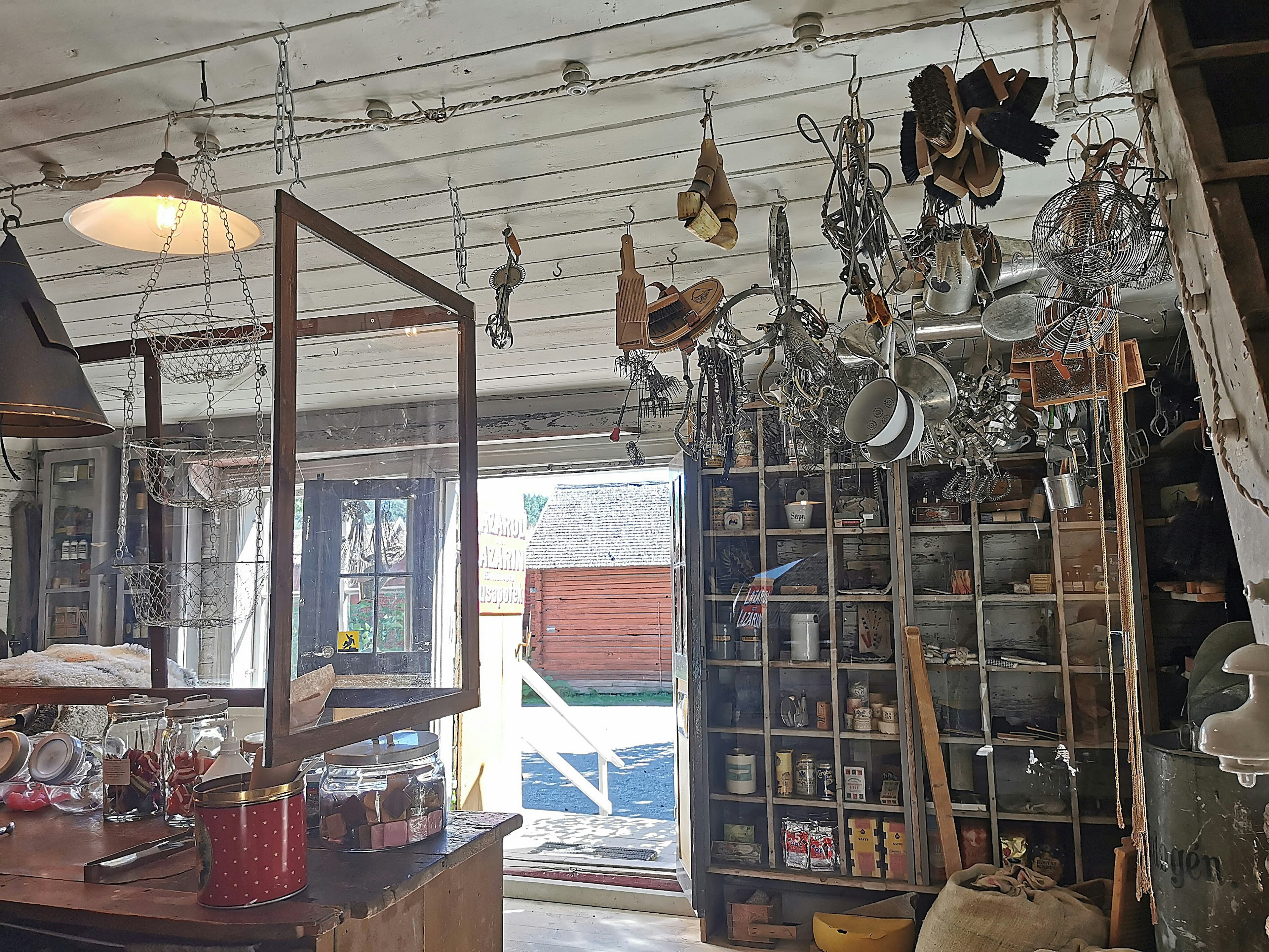 Interior of a shop featuring hanging shoes and decorative items