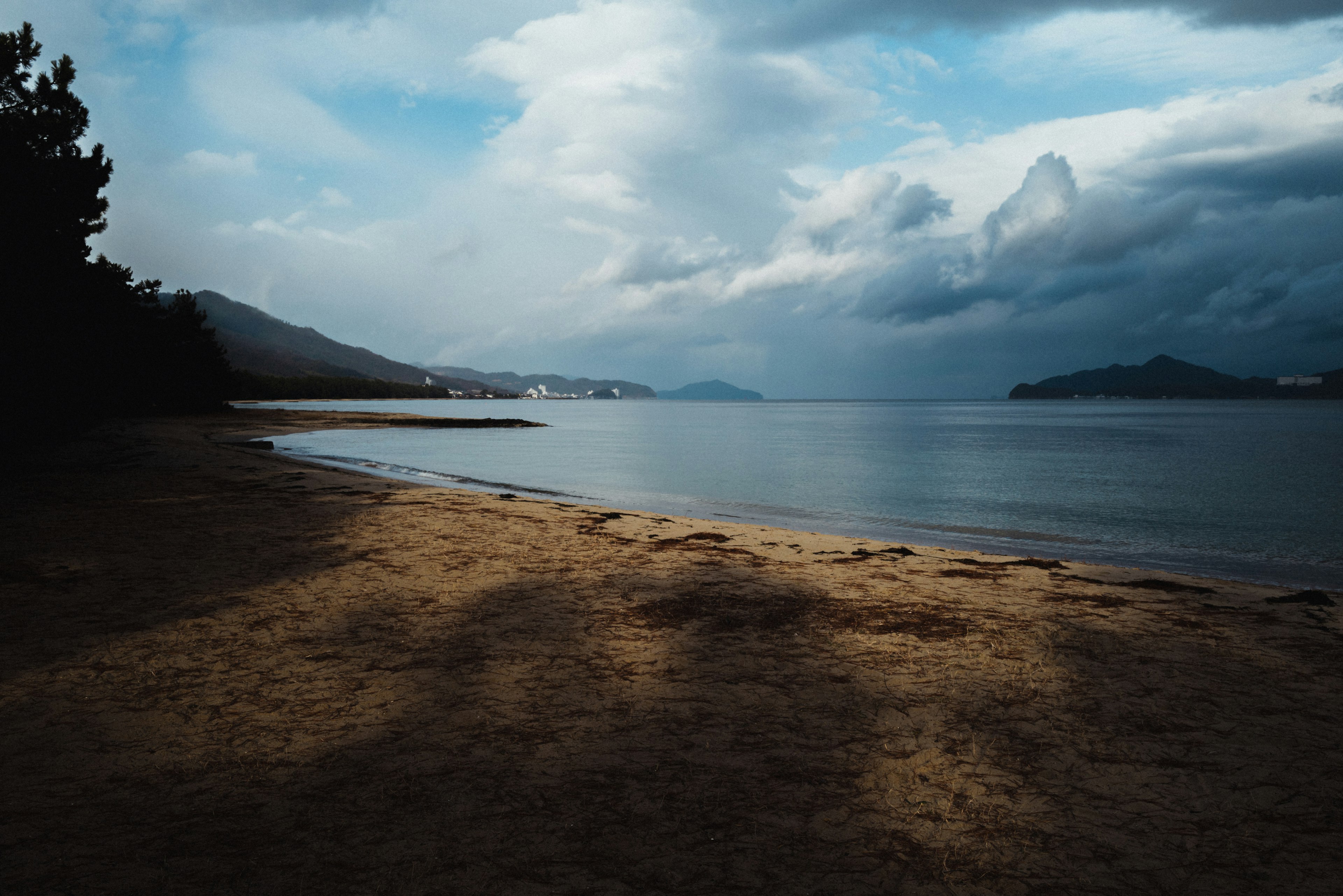 Serene beach with dark clouds overhead