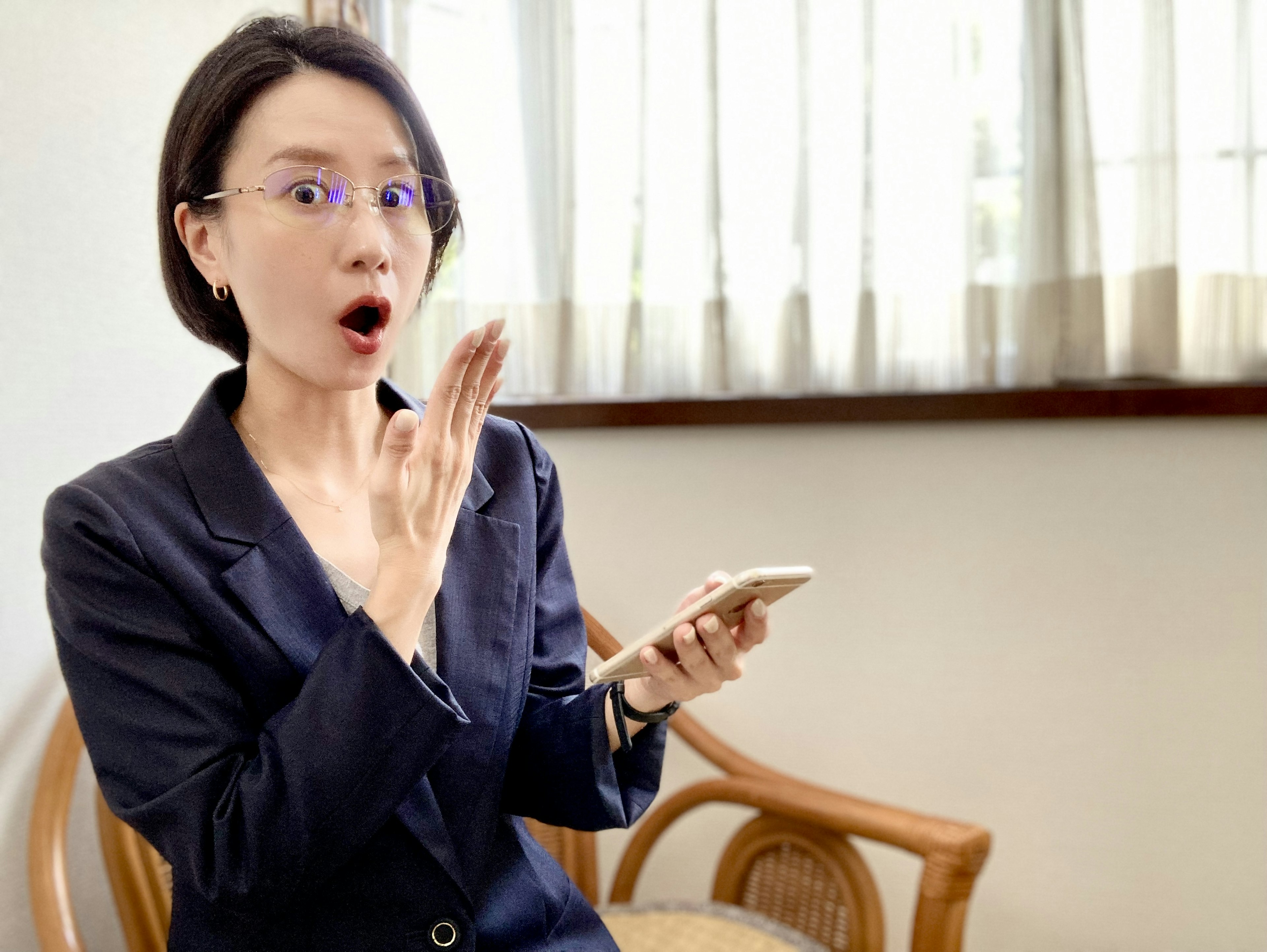 Surprised woman holding a smartphone