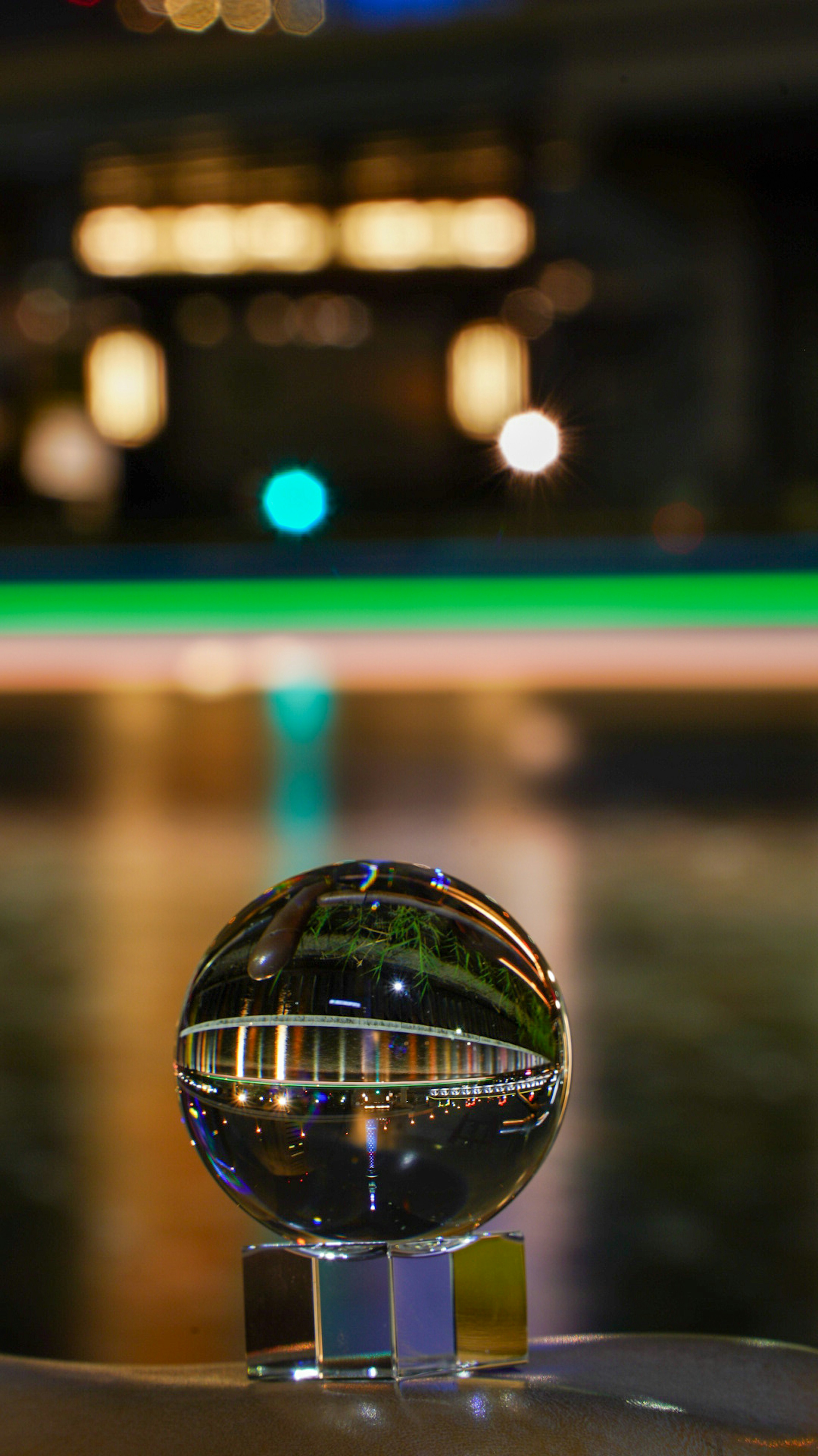 Une boule en cristal transparente posée sur une table reflétant le paysage environnant