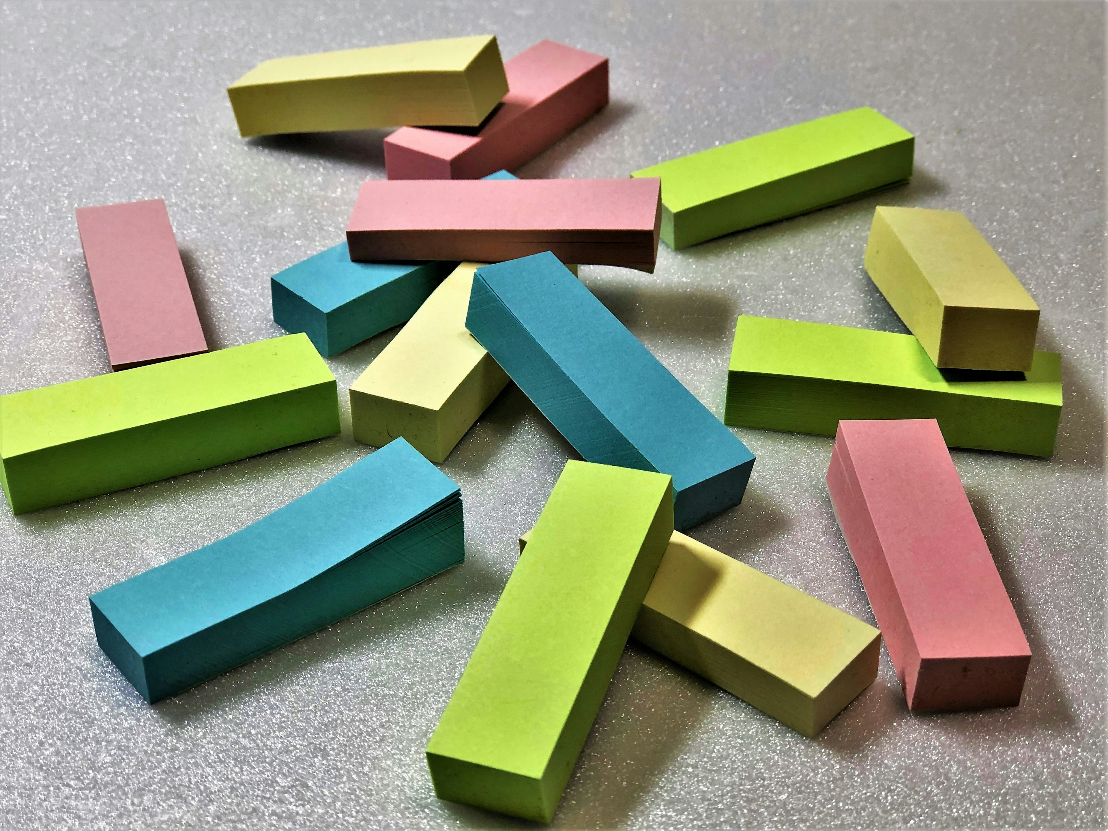 Colorful rectangular sticky notes scattered across a surface