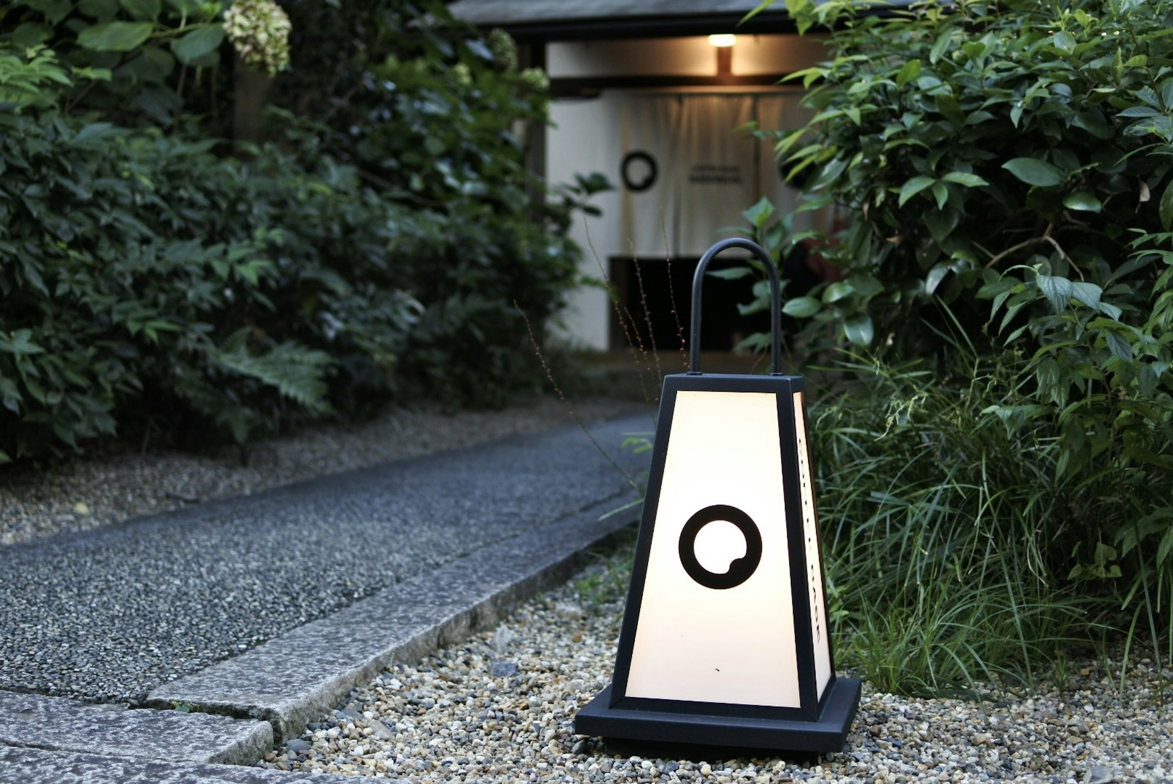 Japanese-style lantern illuminating a garden path