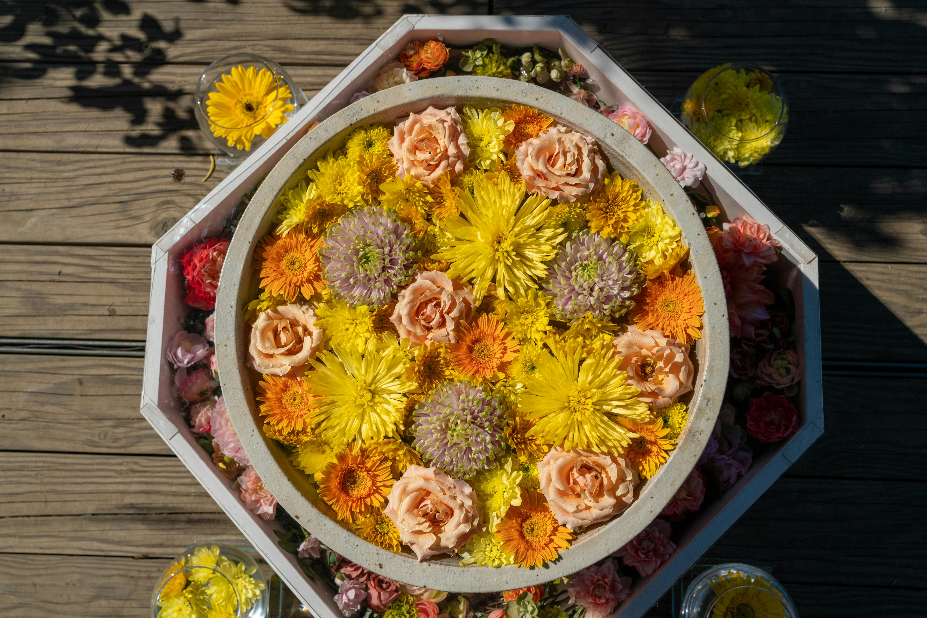 An overhead view of an octagonal tray filled with colorful flowers