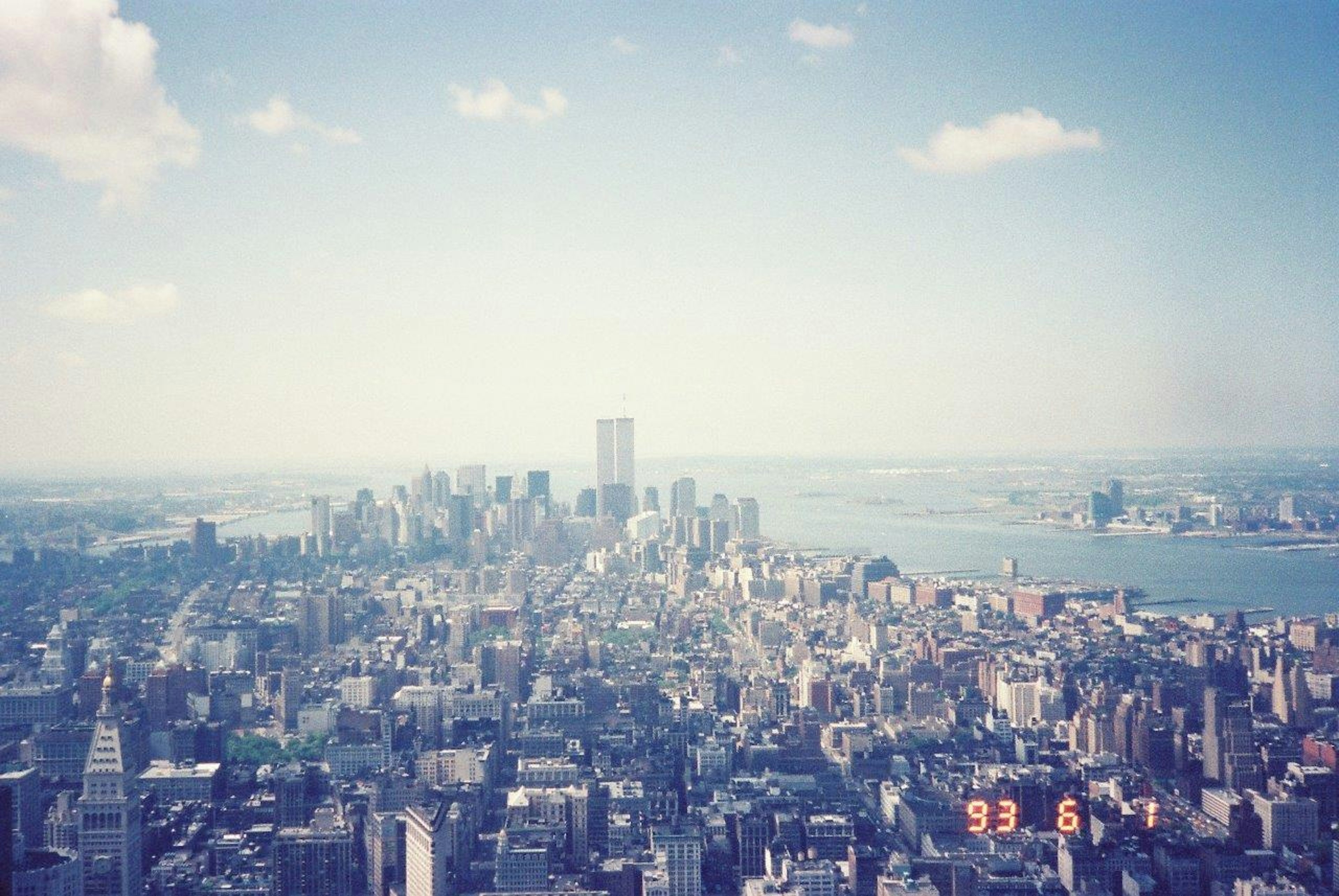 Aerial view of New York City skyline with blue sky and clouds