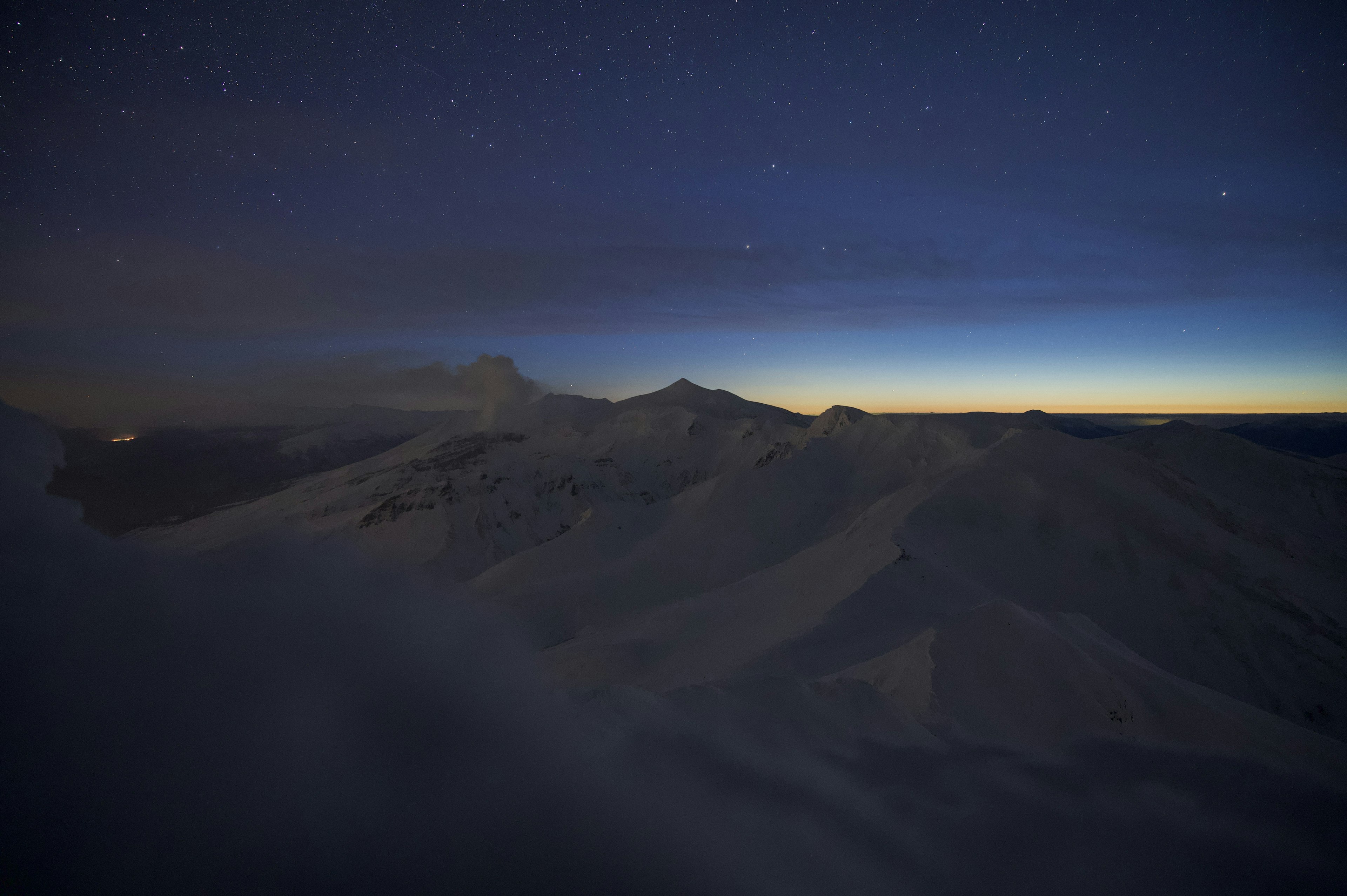 Mountain landscape under a starry night sky