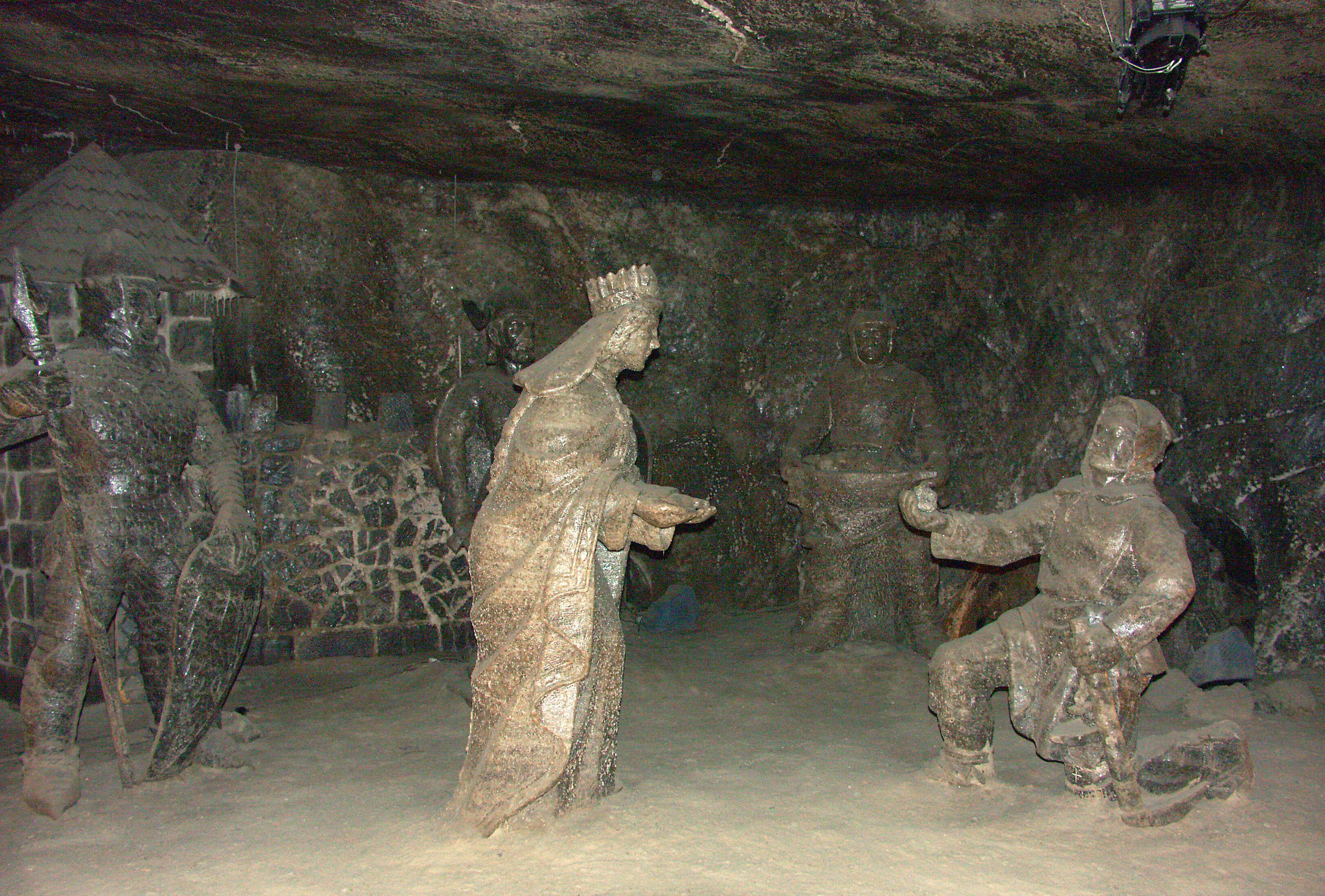 Sculptures in an underground cave depicting a woman and a man engaged in conversation