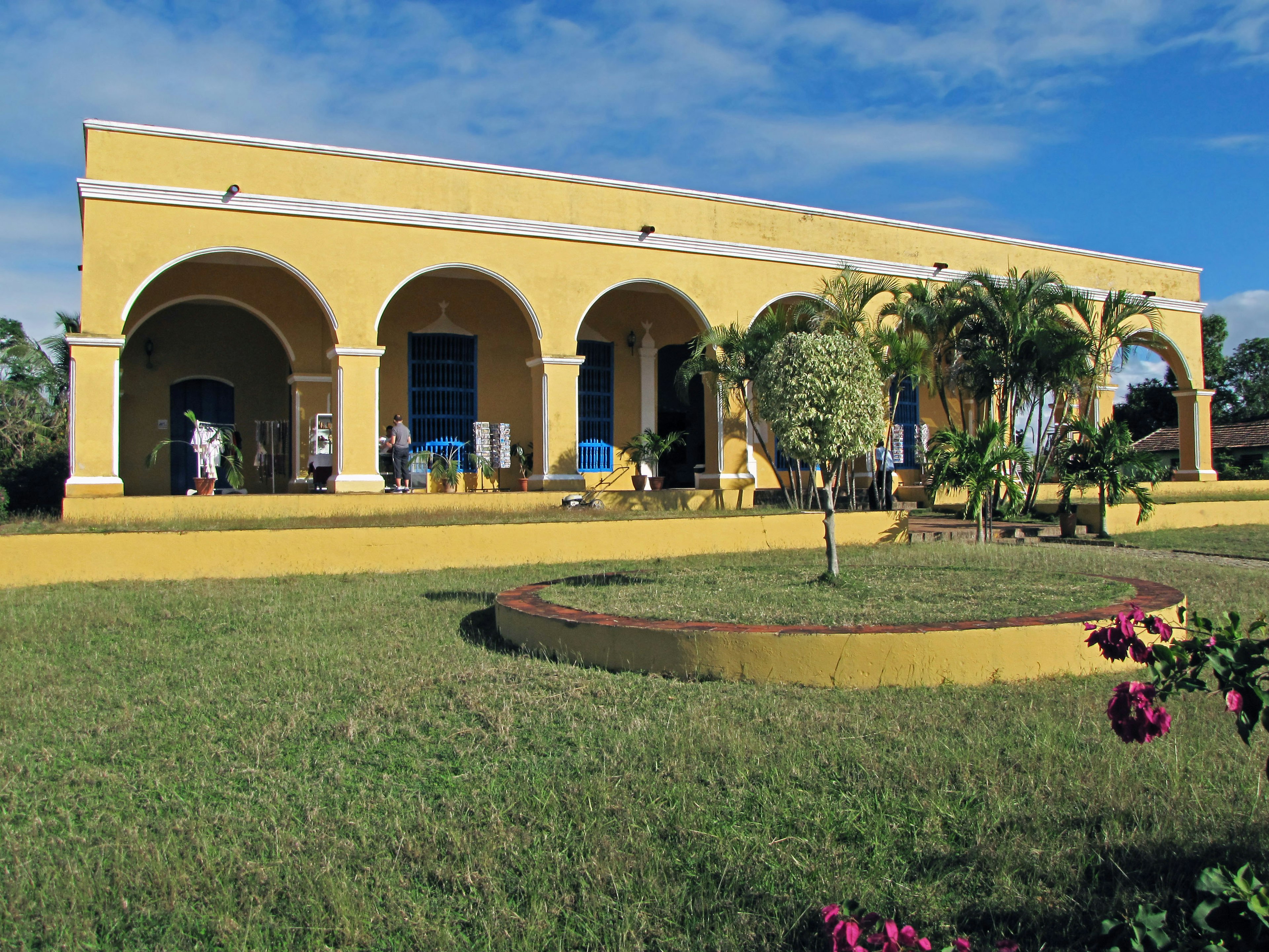 Colorful yellow building with lush garden landscape