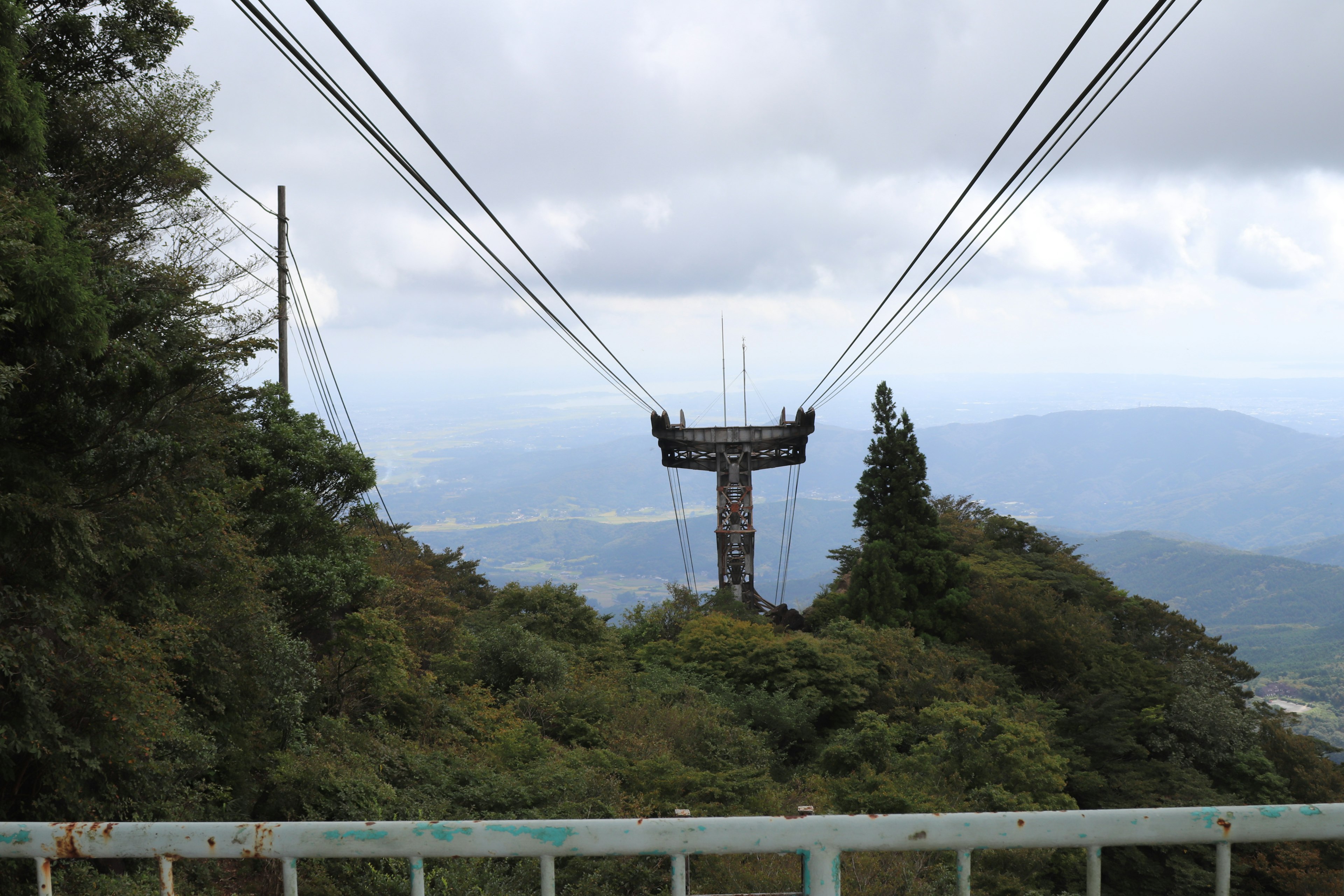 Scenic view of a cable car tower and cables at a mountain top