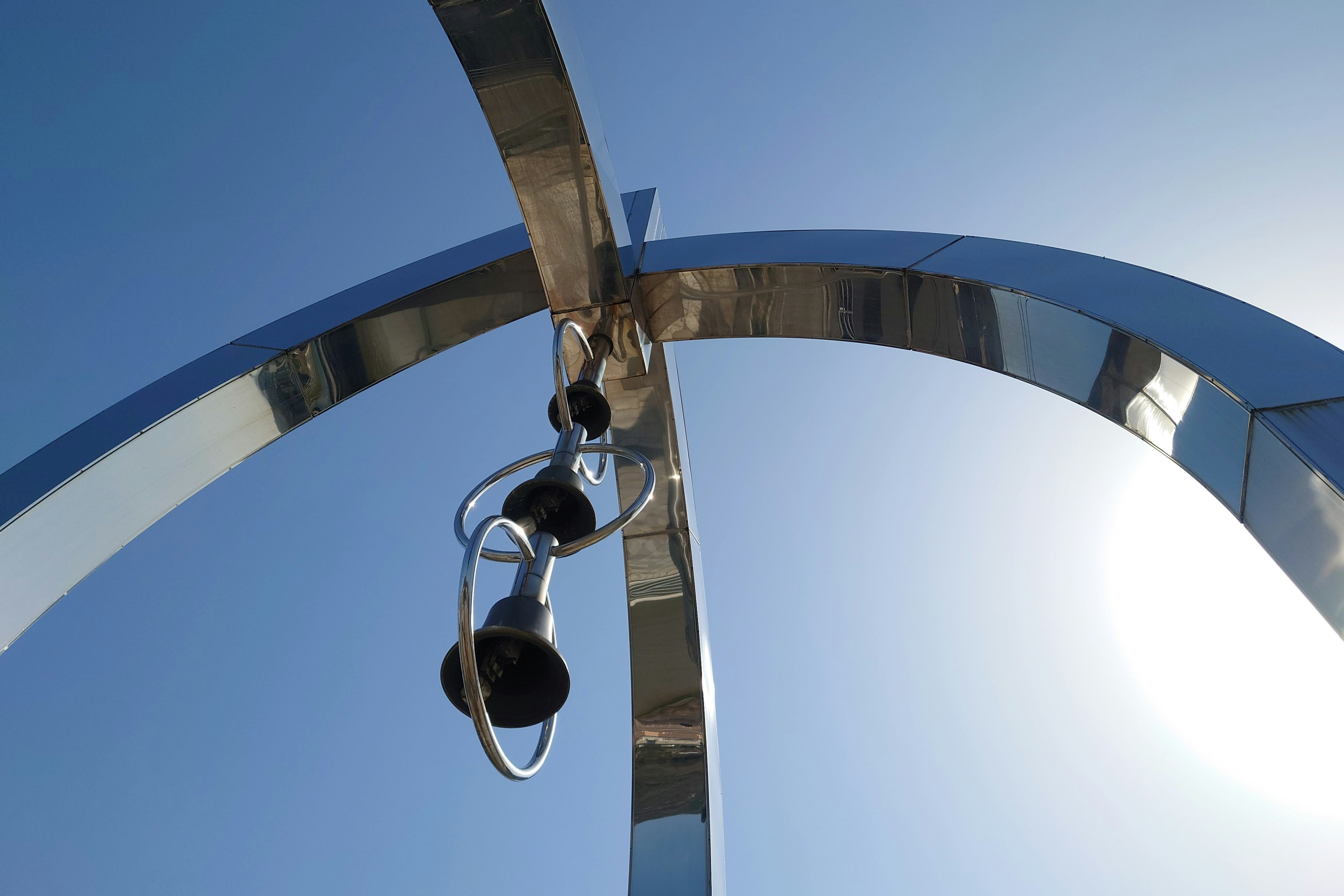 Sculpture featuring metallic arches and black speakers