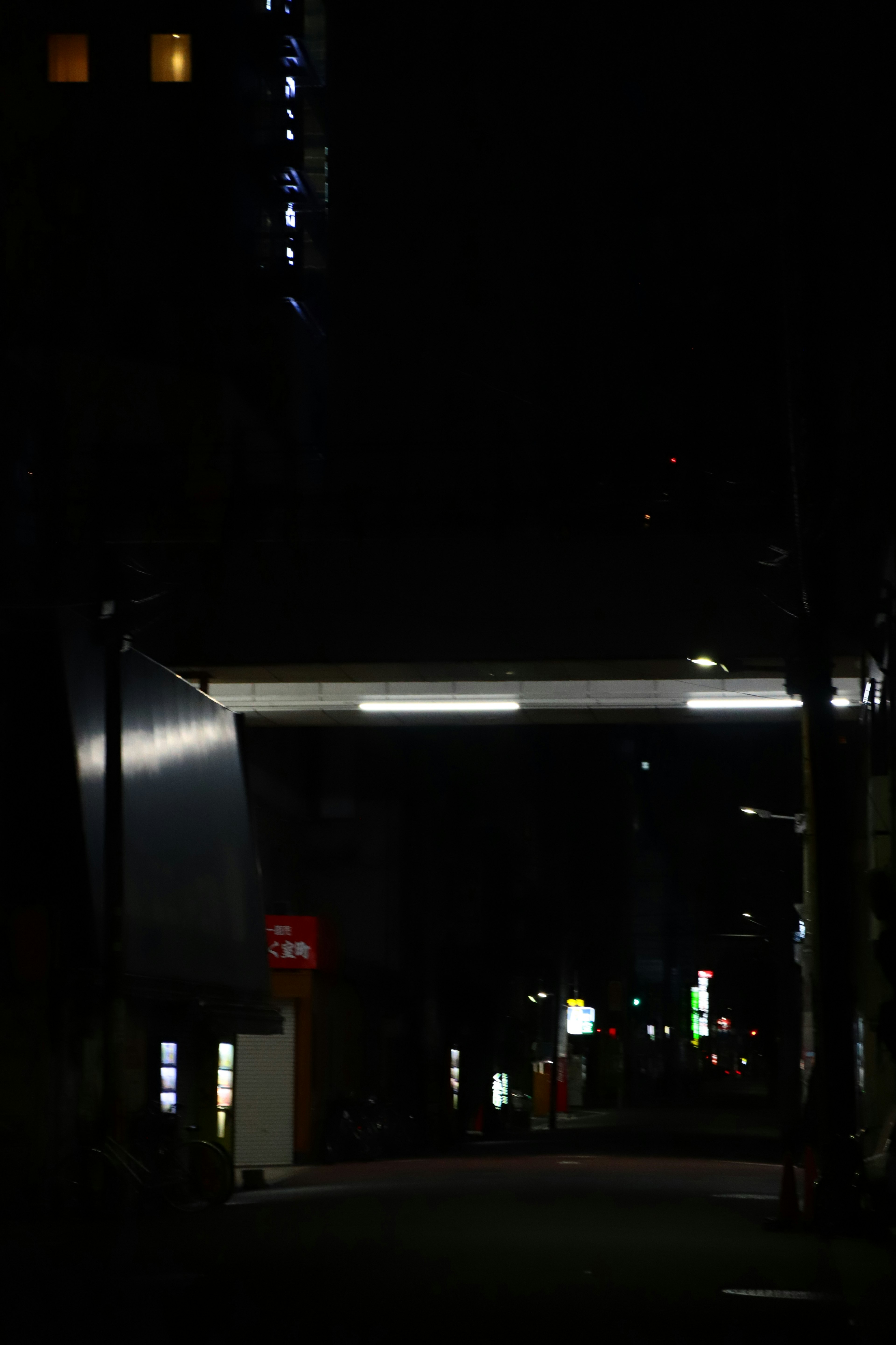 Illuminated silhouettes of buildings in a dark city street at night