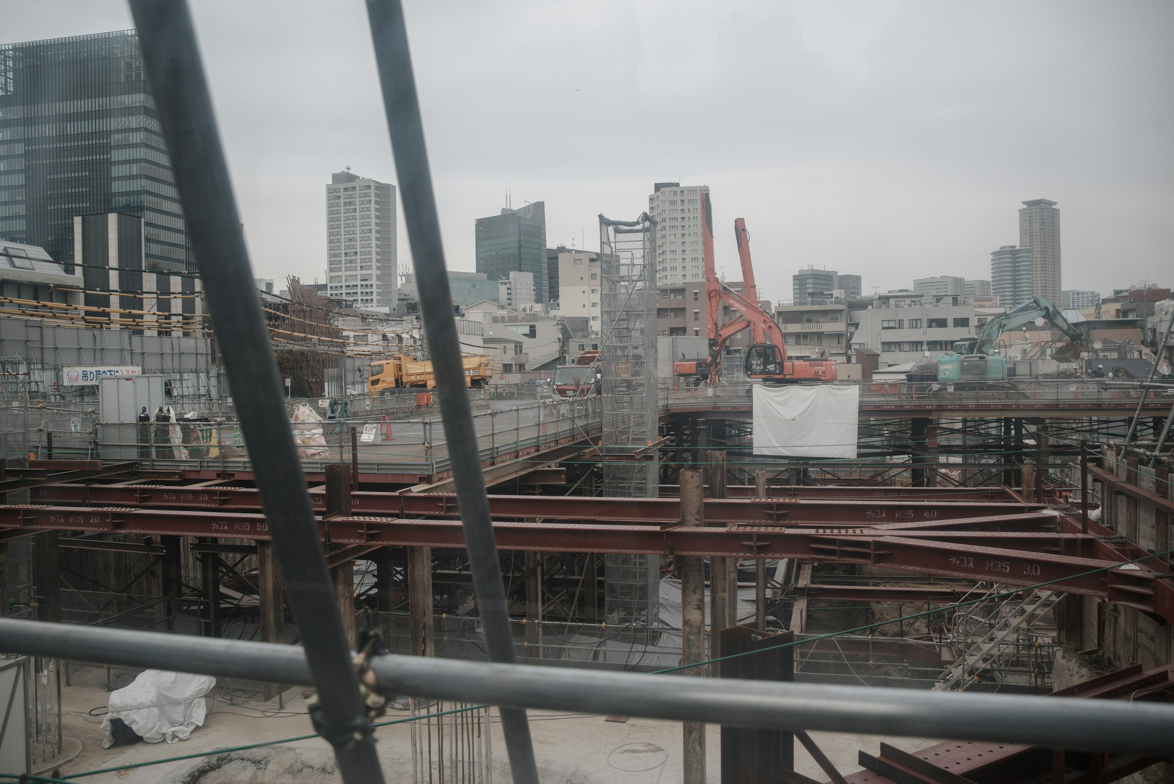 Urban construction site view featuring steel structures and heavy machinery