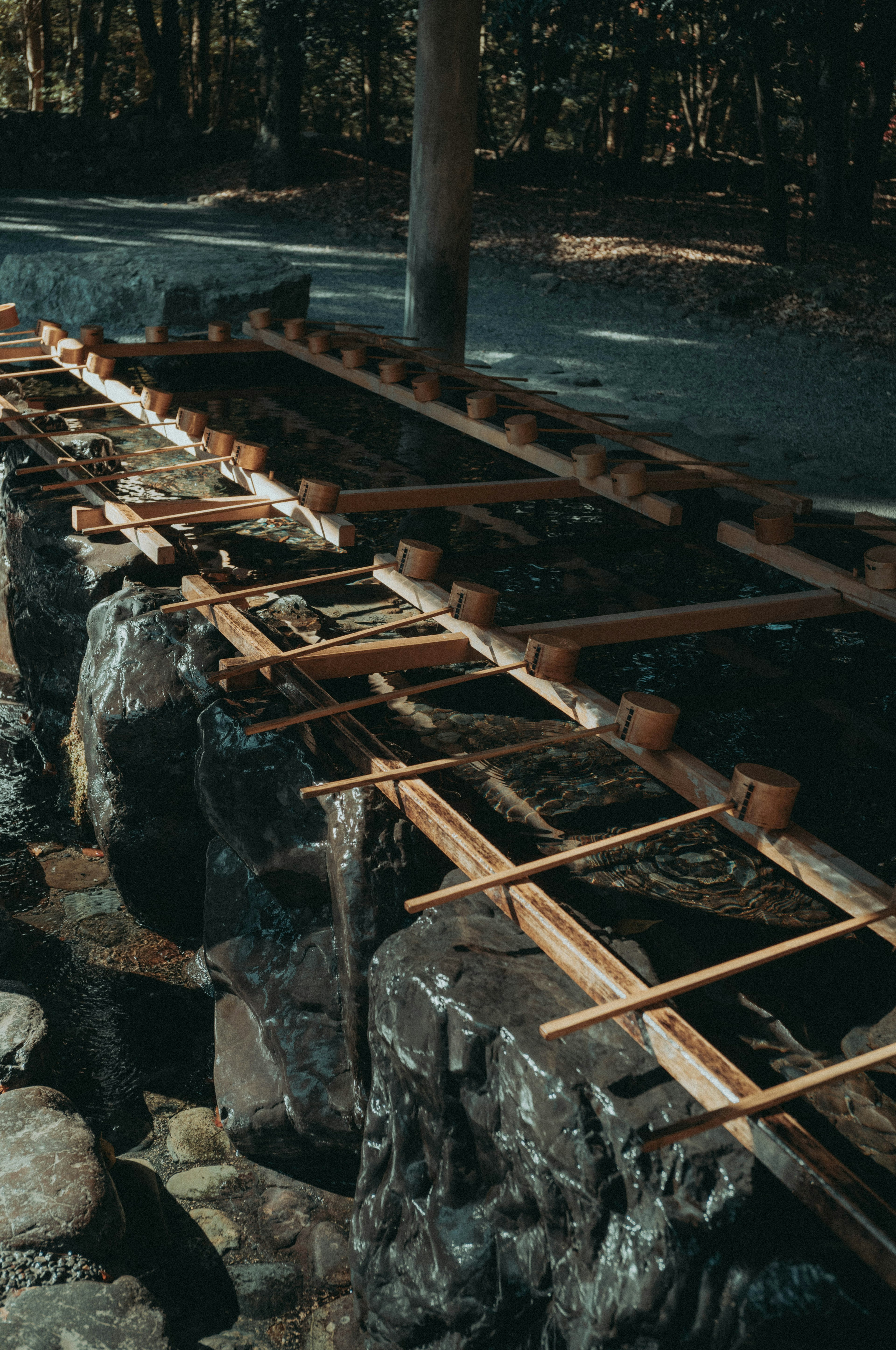 A wooden structure placed over rocks in a natural setting