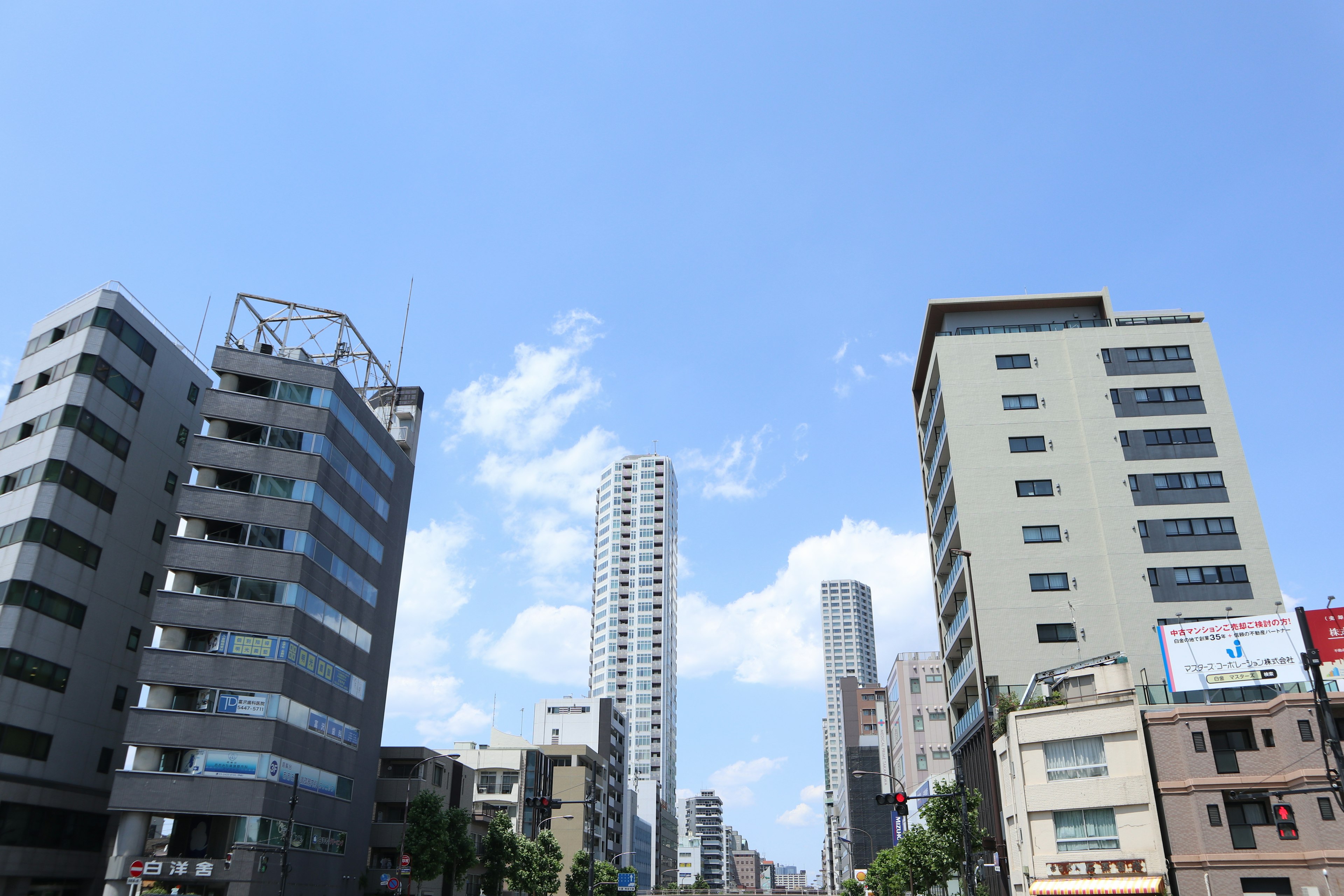 Cityscape with tall buildings under a clear blue sky