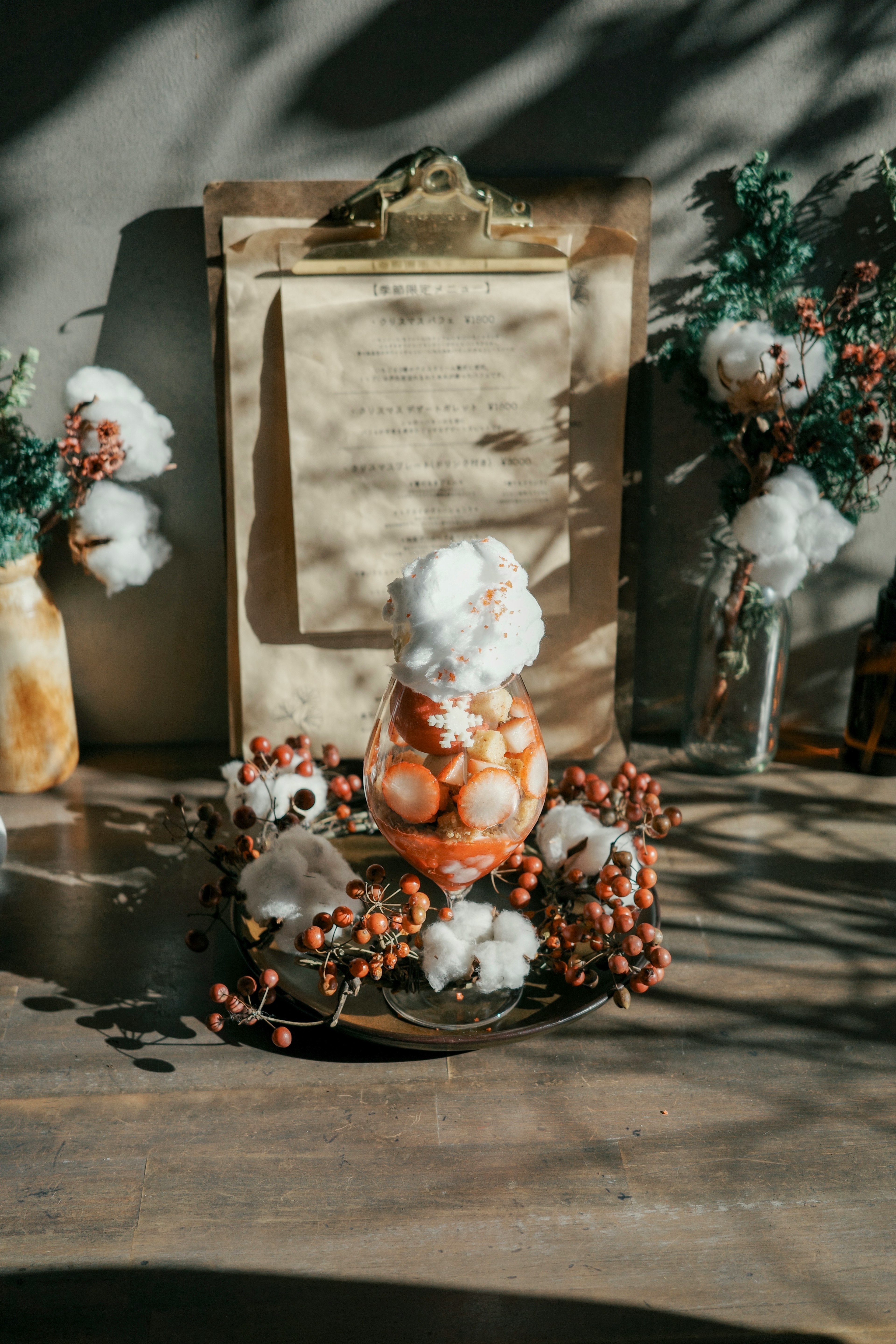 A decorative arrangement of vases and floral elements on a table