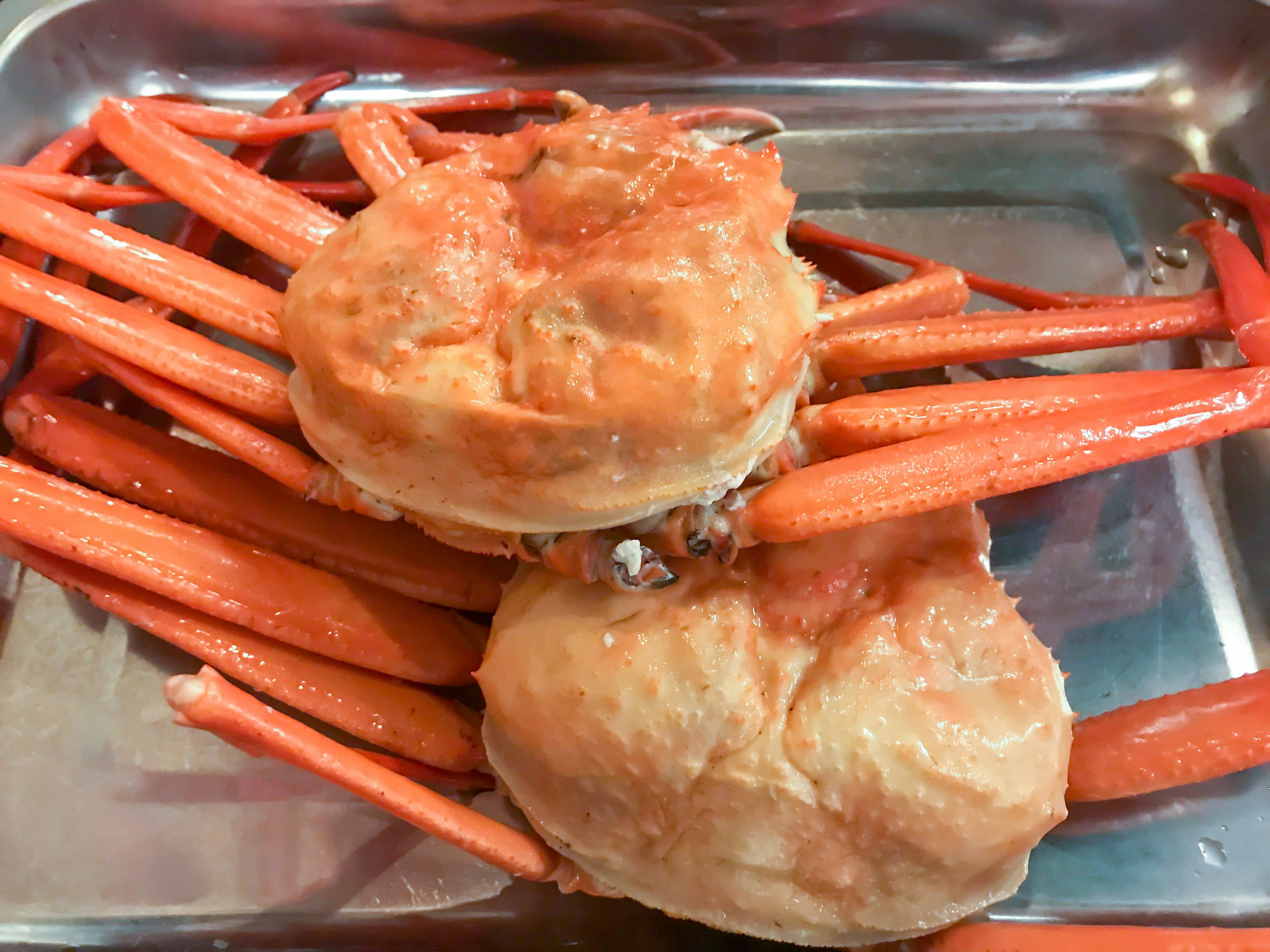 Vibrant red crab legs and soft body parts placed on a tray