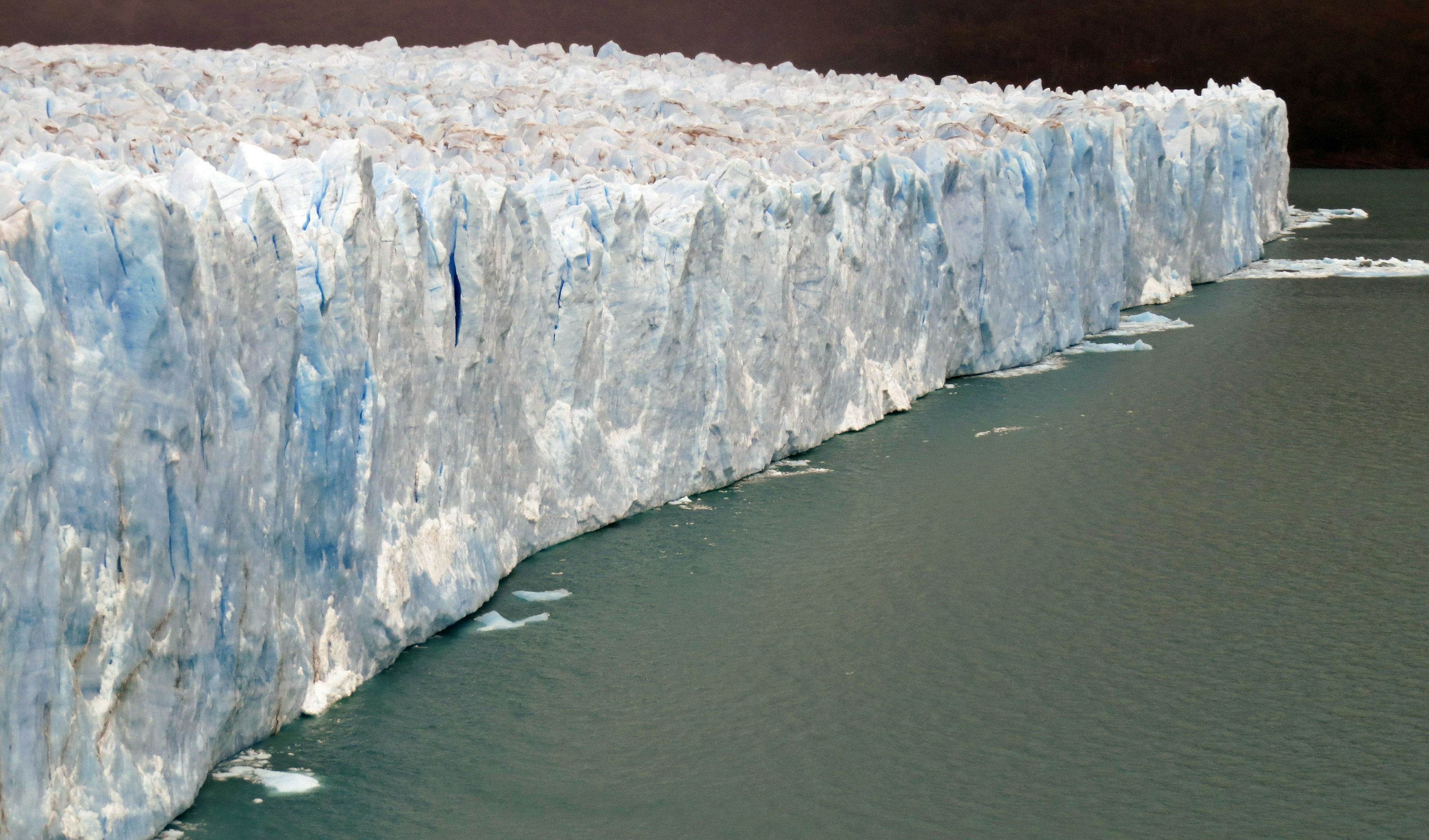 Vast glacier edge towering over turquoise waters