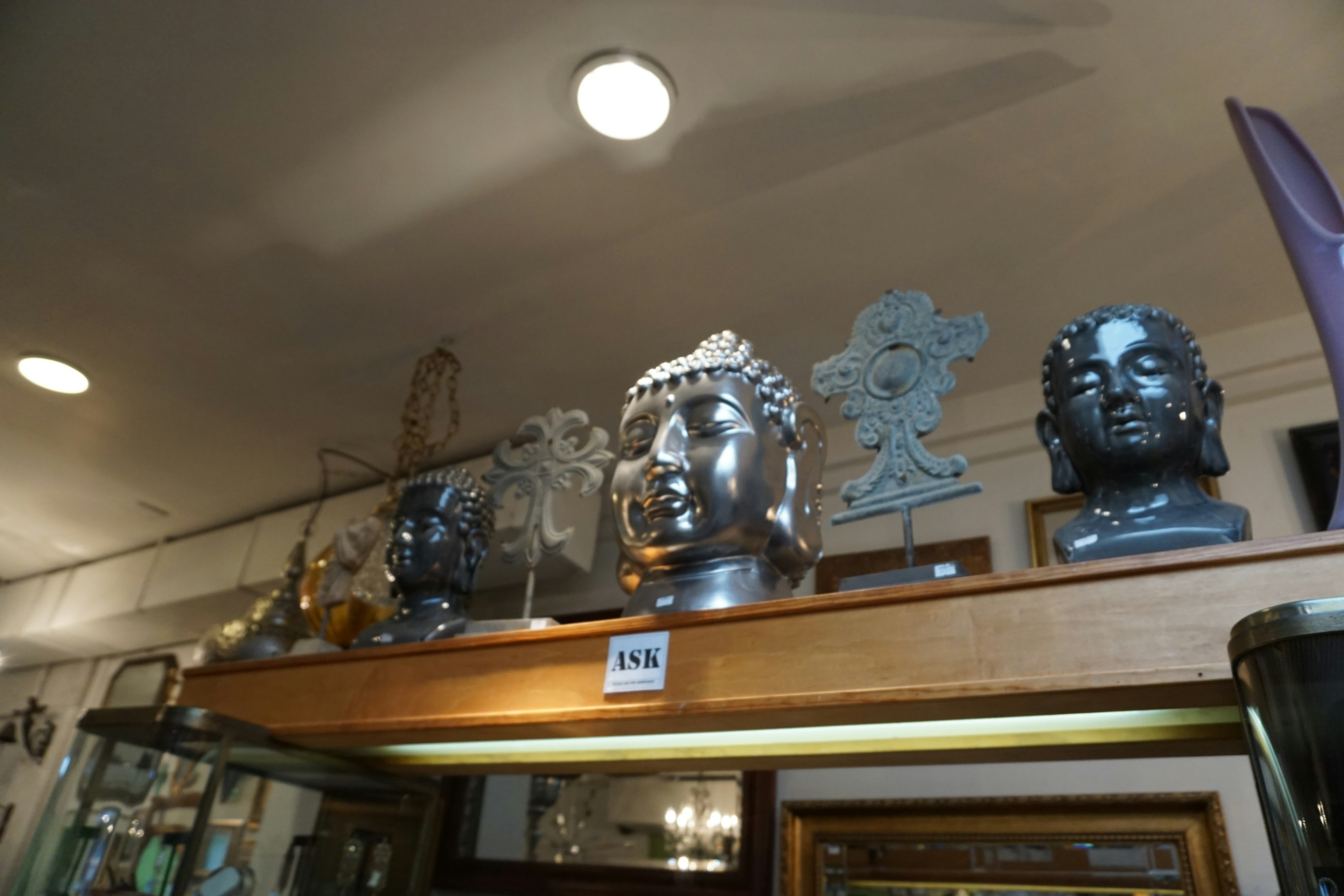 Sculptures and decorative items of Buddha statues displayed on a shelf