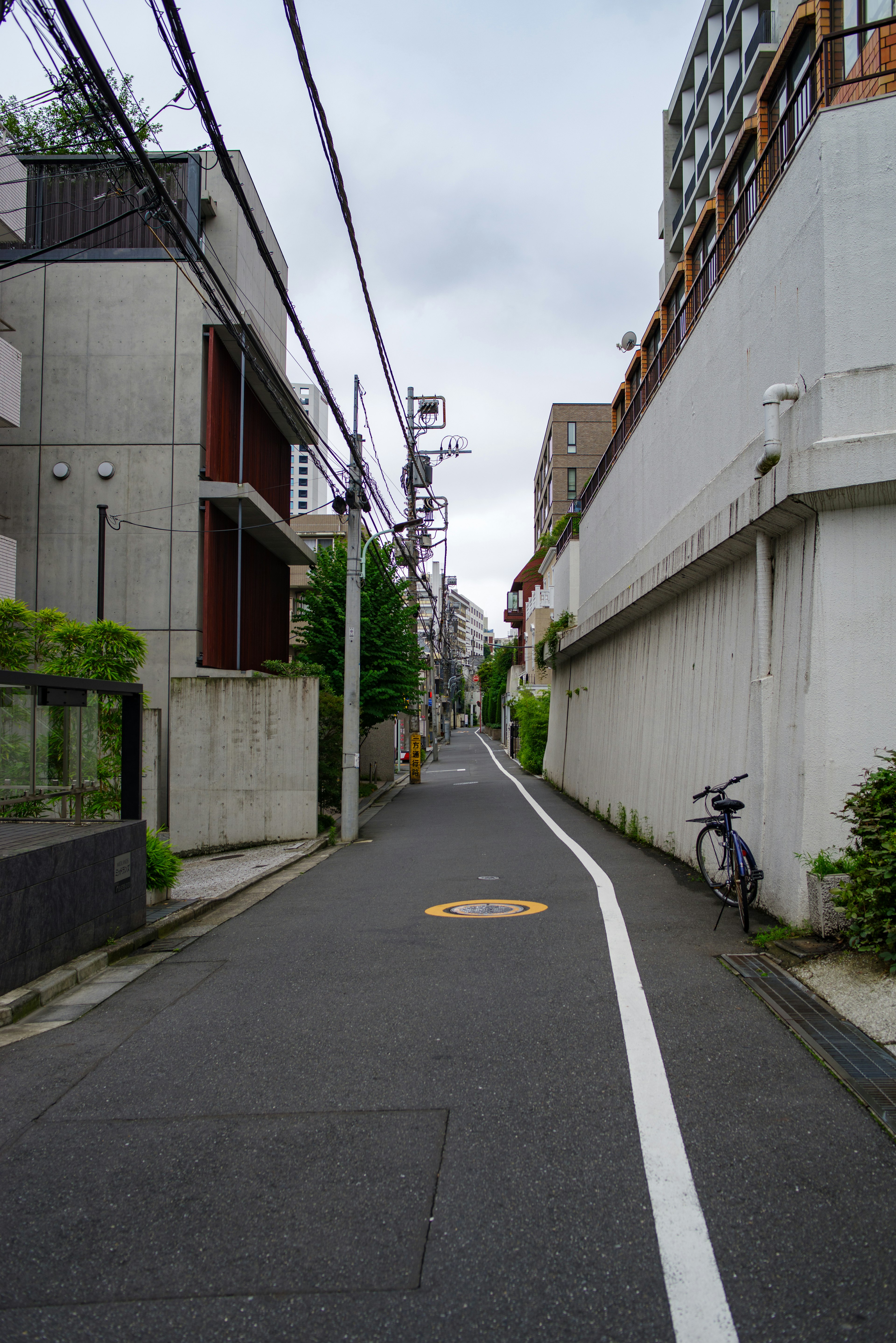 Narrow street lined with buildings and overhead power lines