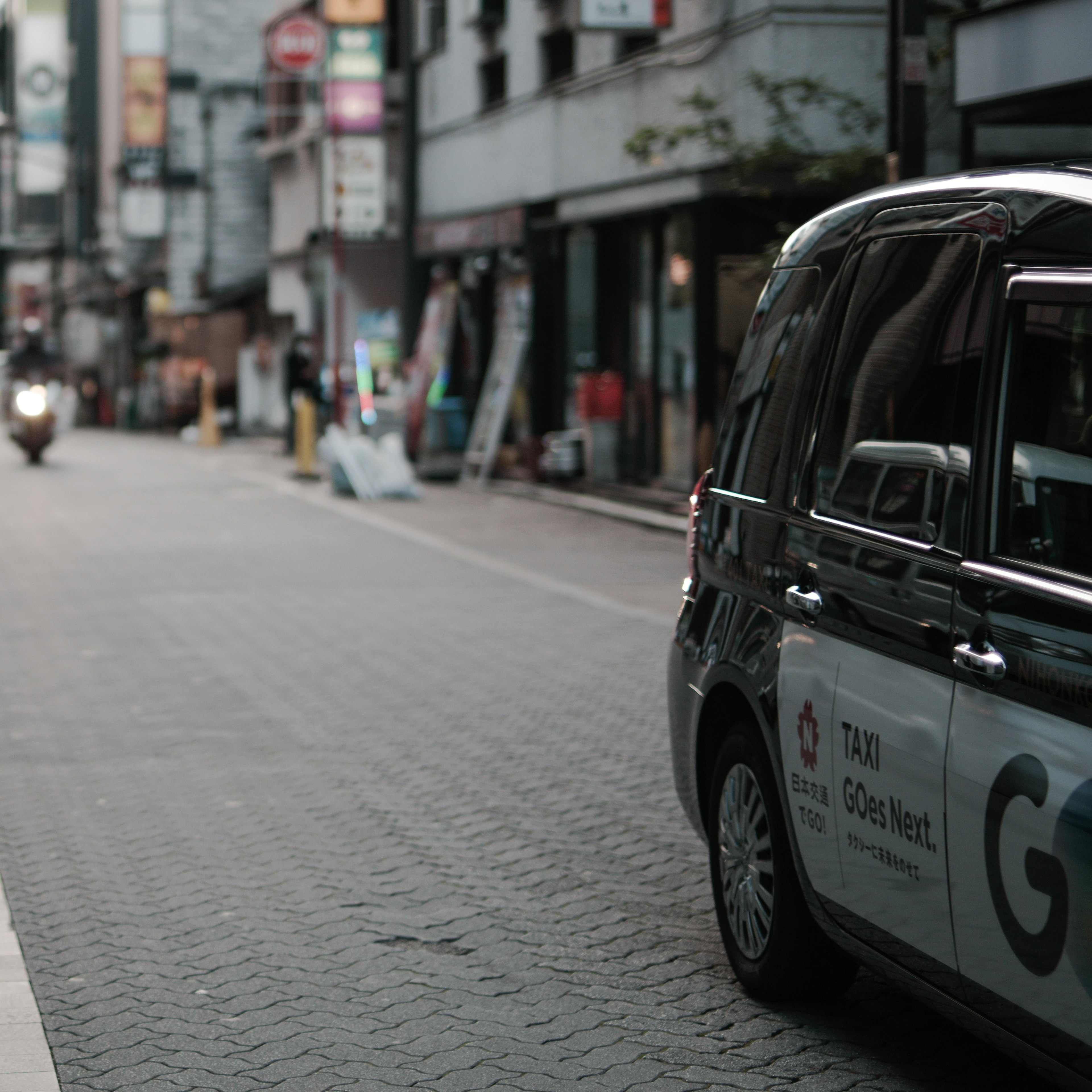 Taxi estacionado en una calle urbana tranquila con peatones