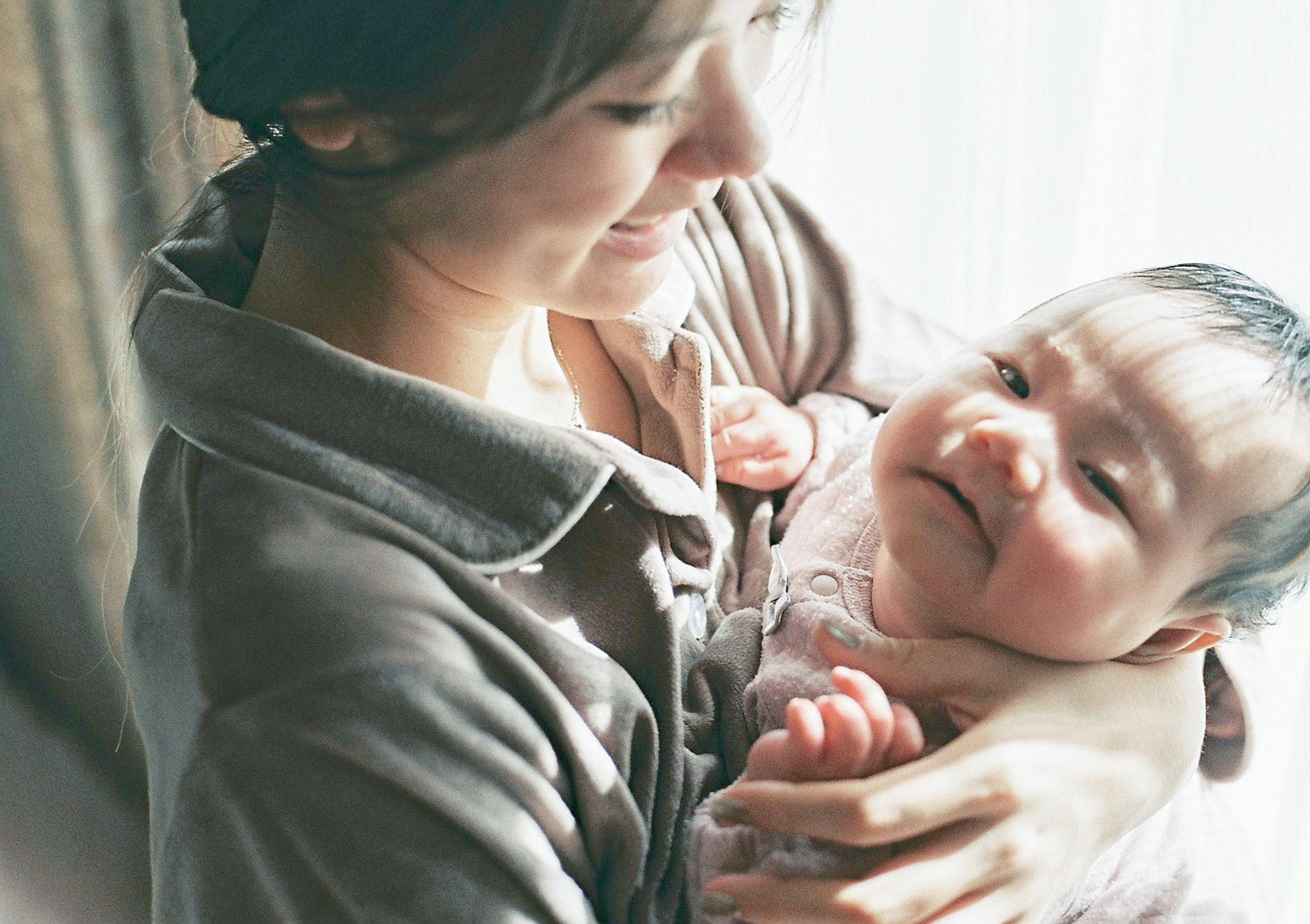 Mother smiling while holding her baby