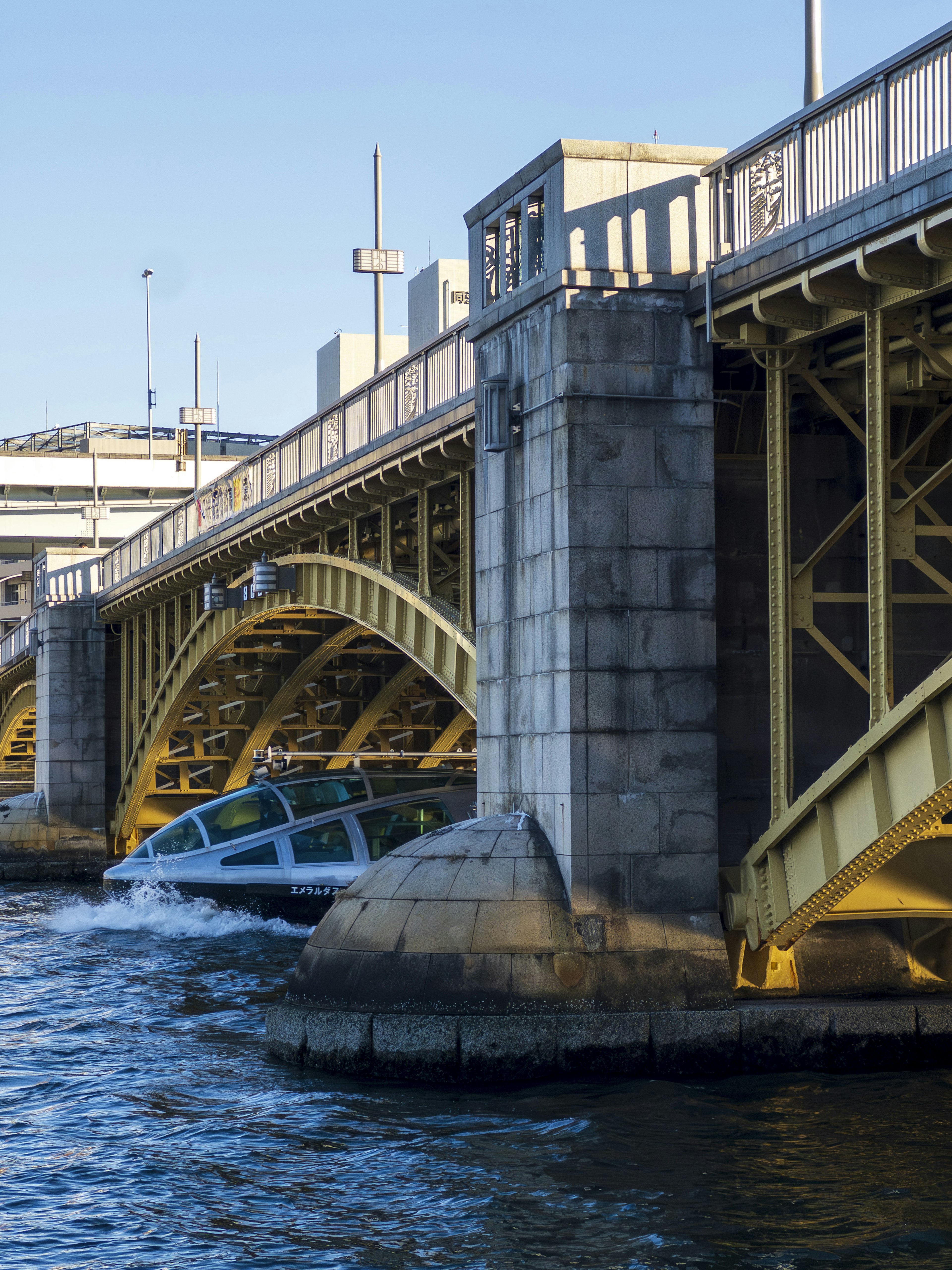 Primo piano di un ponte ad arco giallo su un fiume