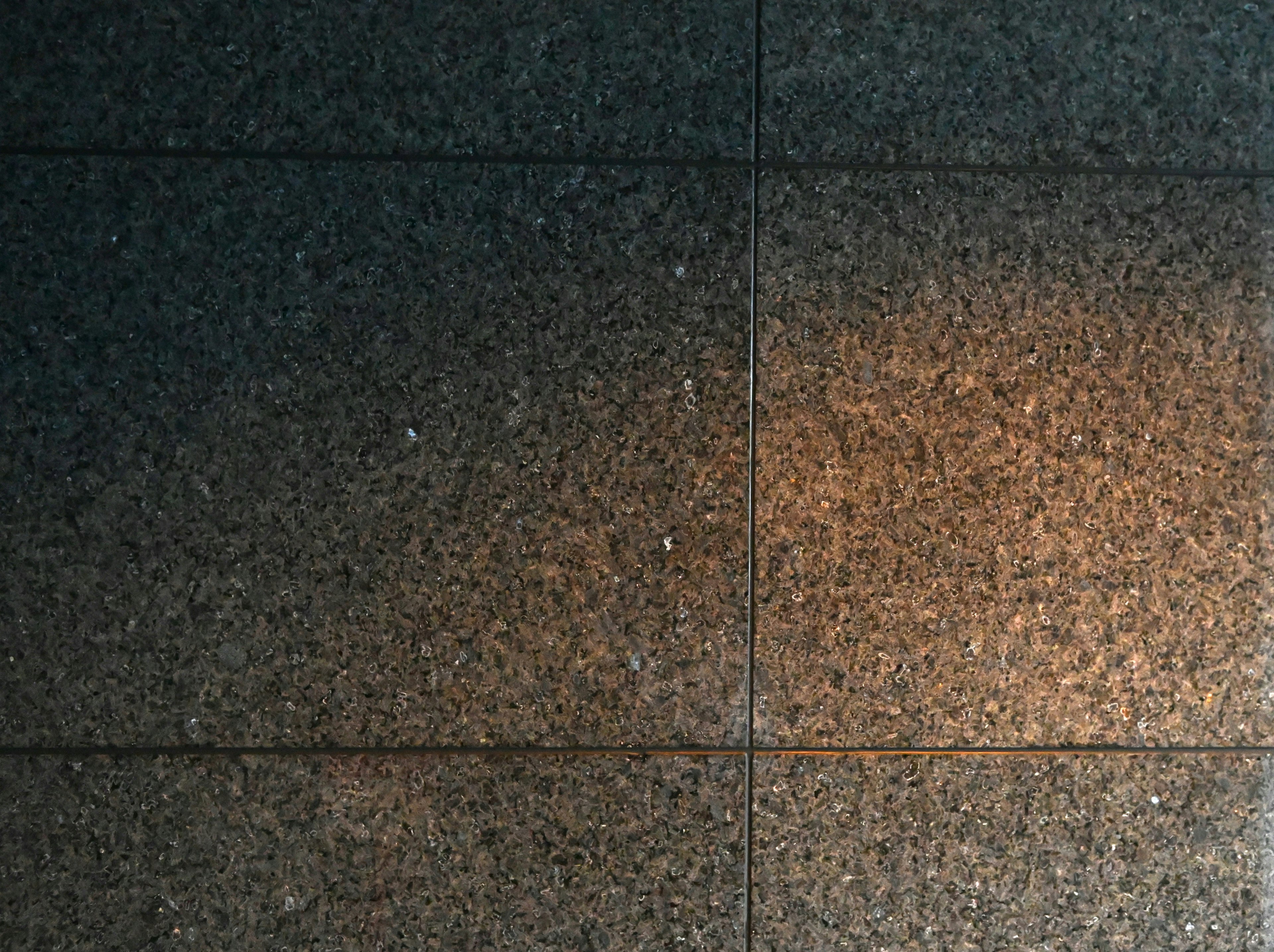 Image of a polished stone tile surface with gradient lighting