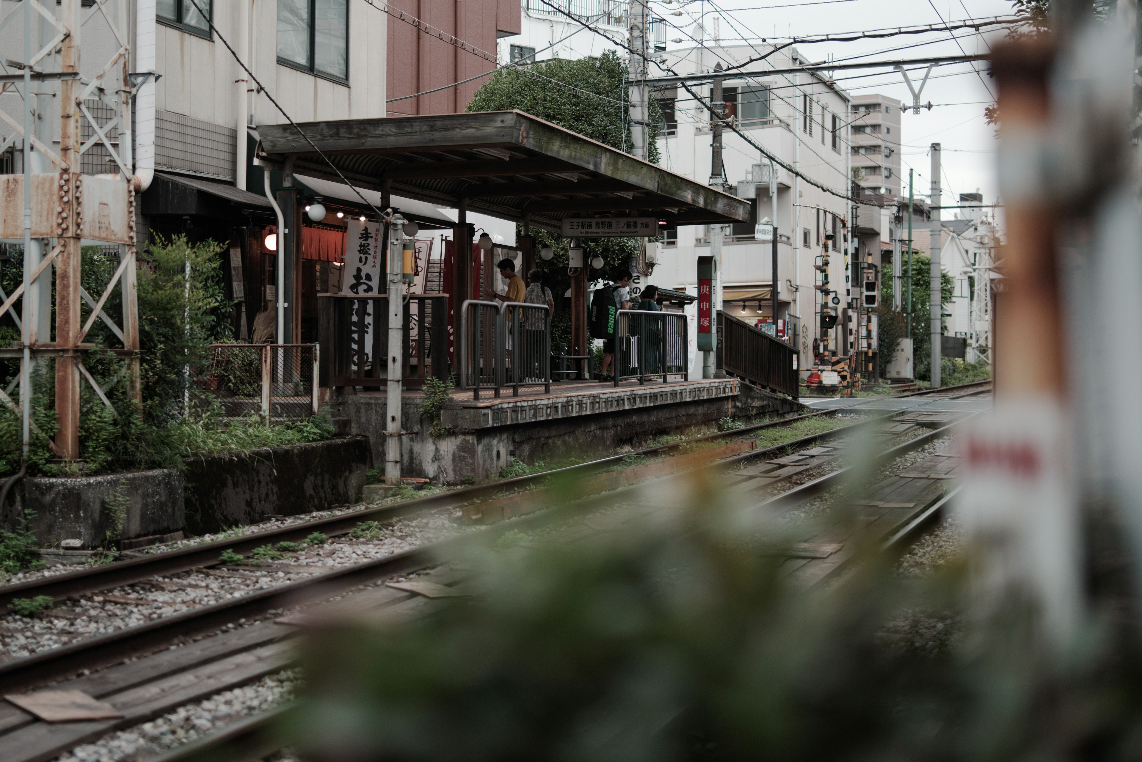 Quiet station platform with railway tracks