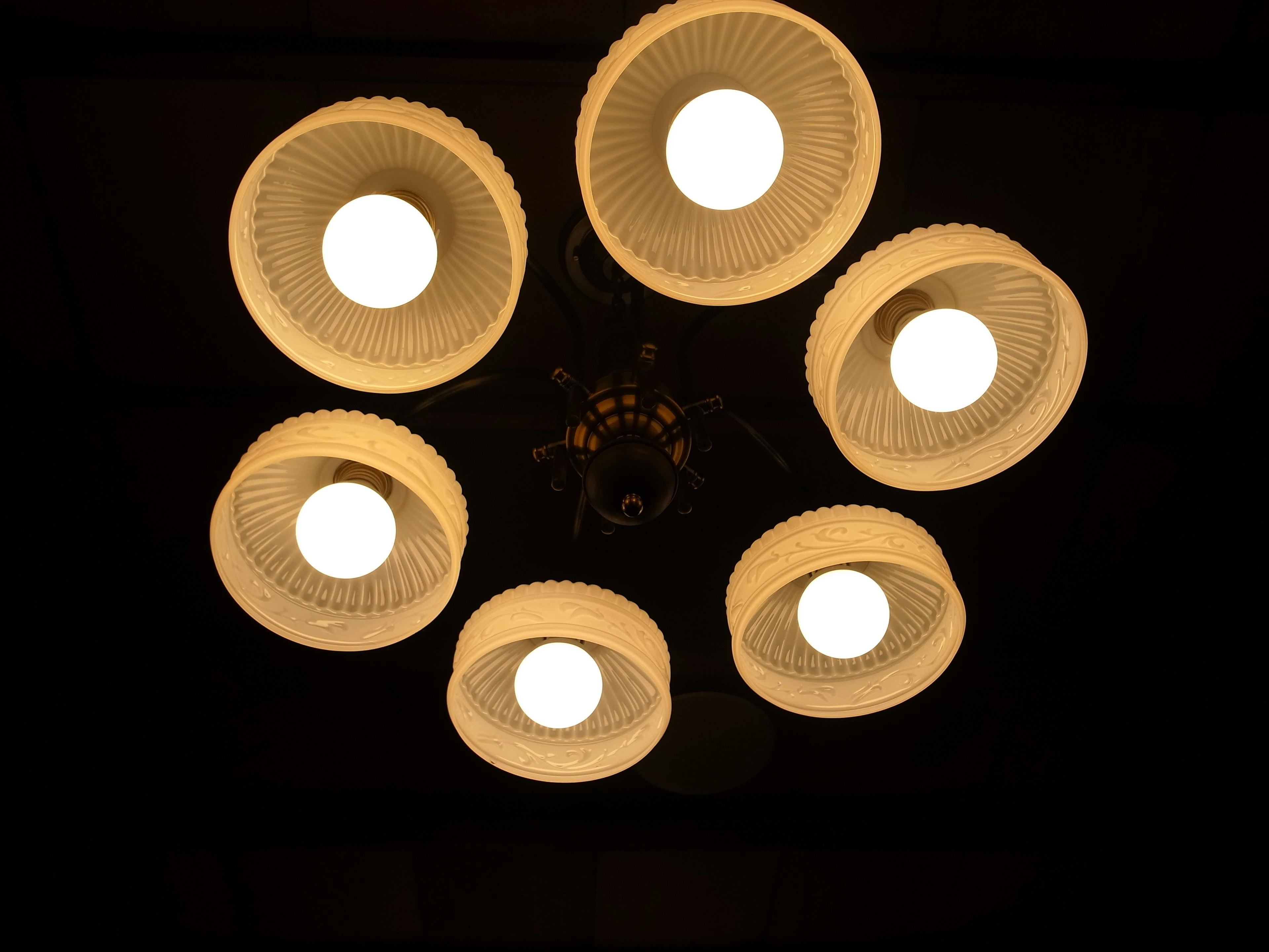 Chandelier with six light bulbs hanging from the ceiling