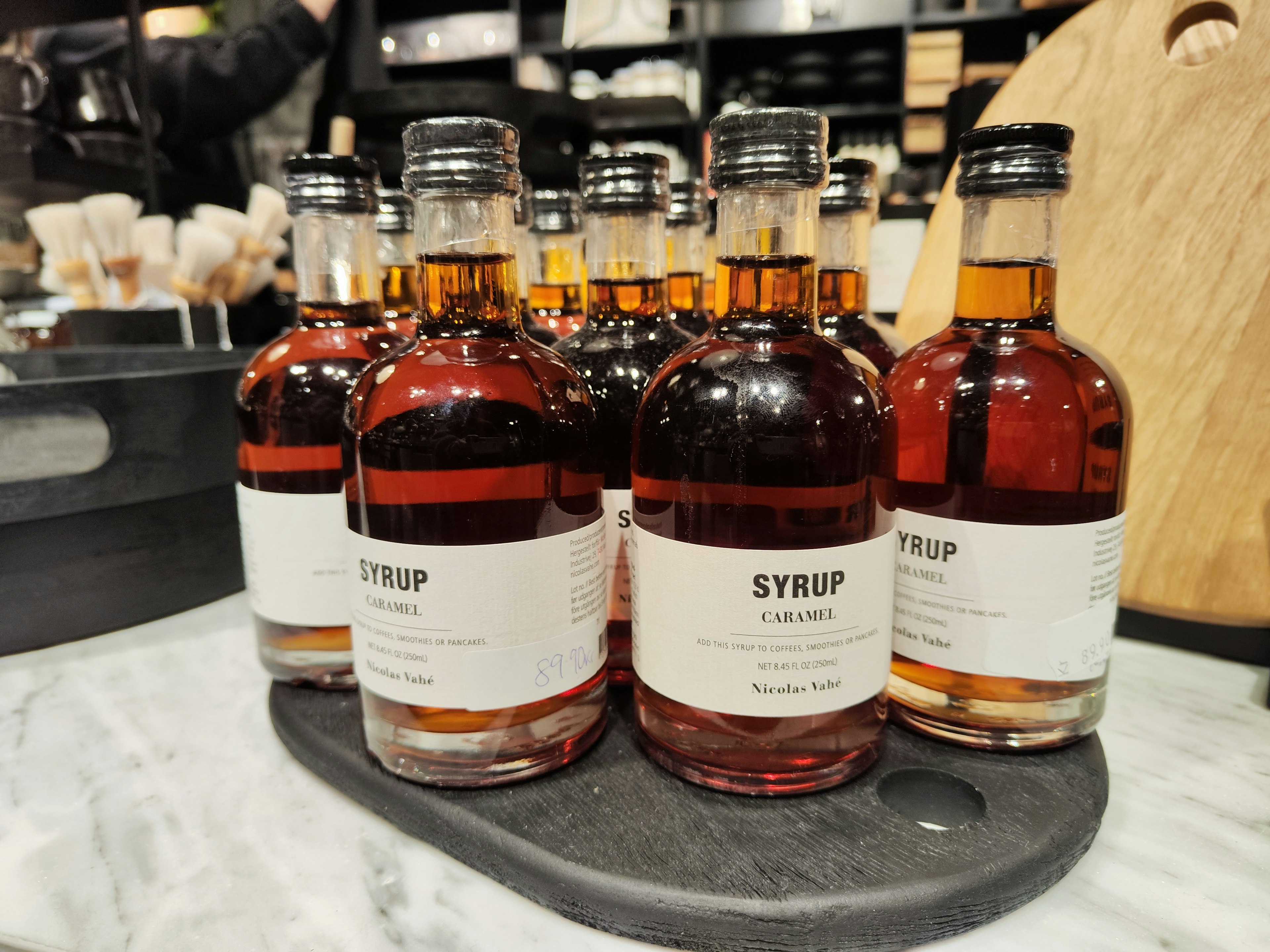 A collection of small syrup bottles displayed on a tray