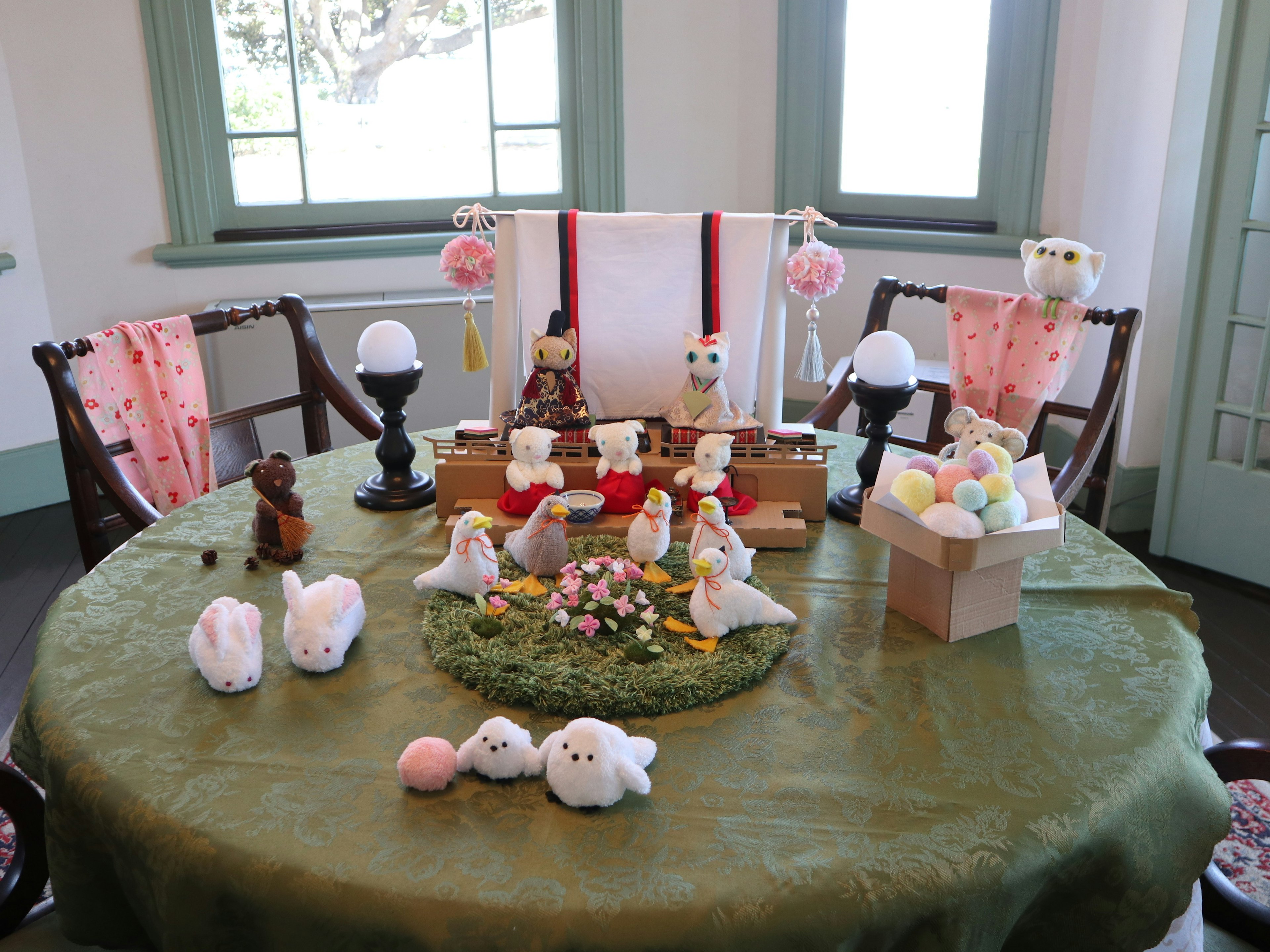 A table decorated with cute animal figurines and a flower arrangement