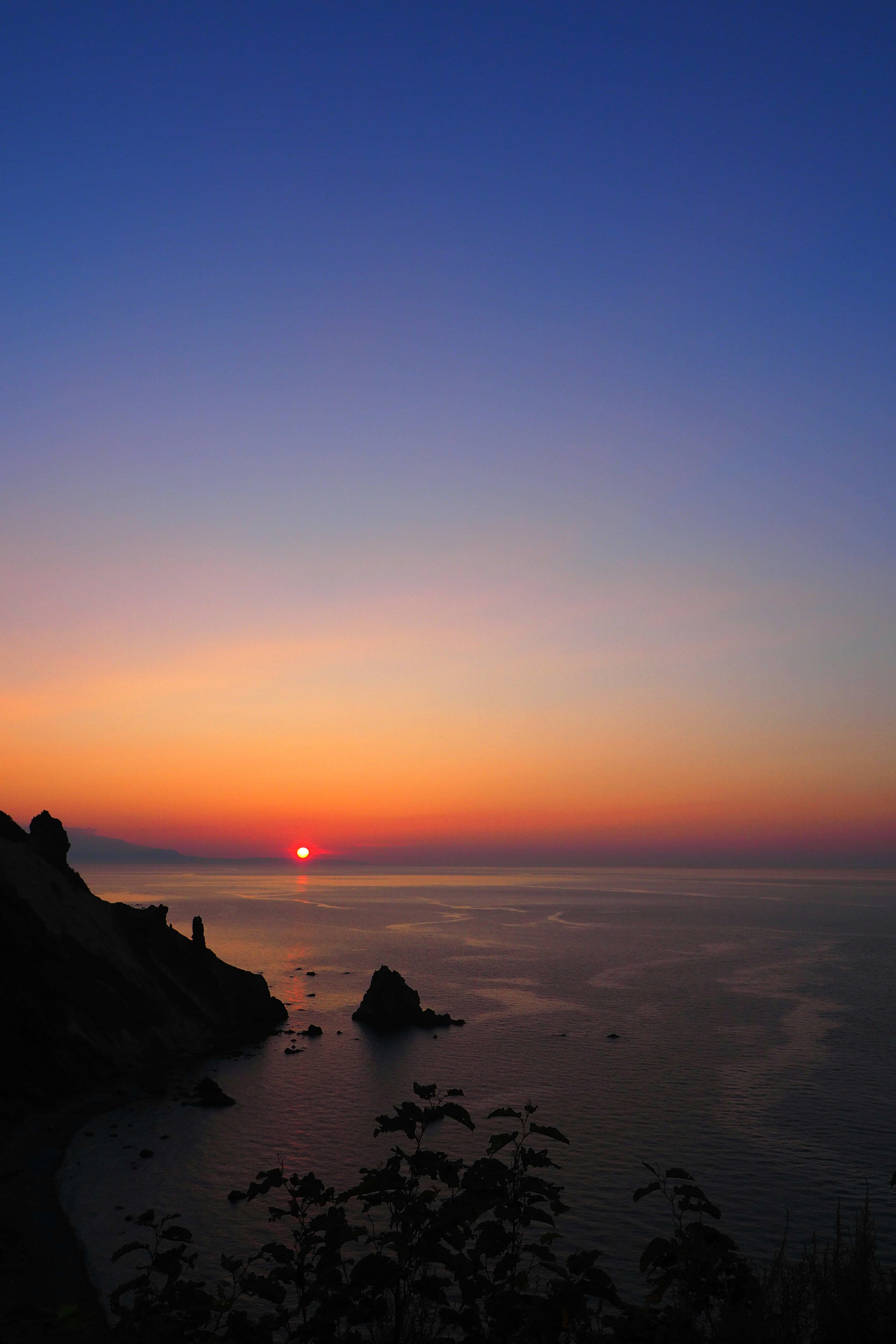 Beautiful sunset over the ocean with silhouettes of cliffs