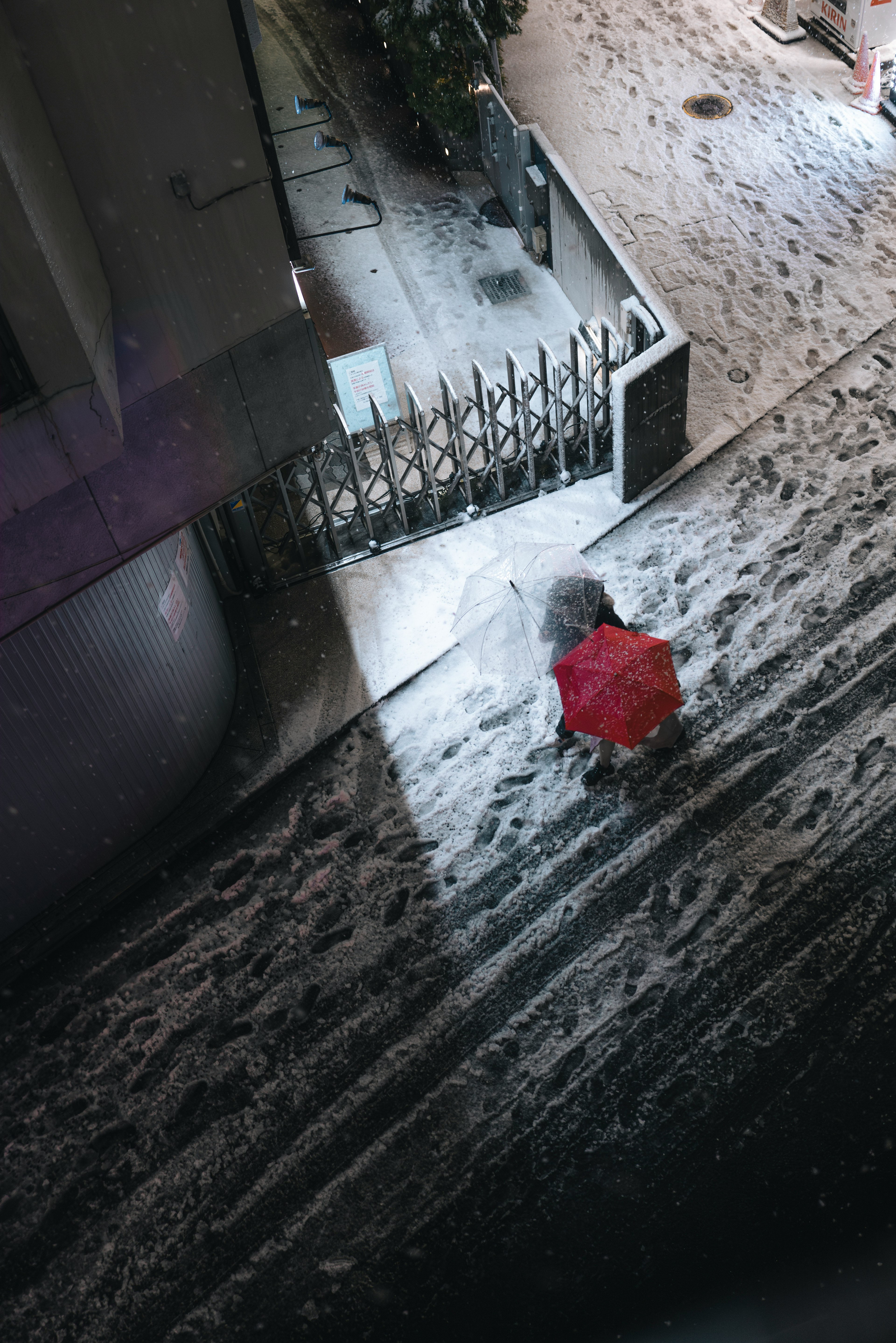 Person walking with a red umbrella in the snow