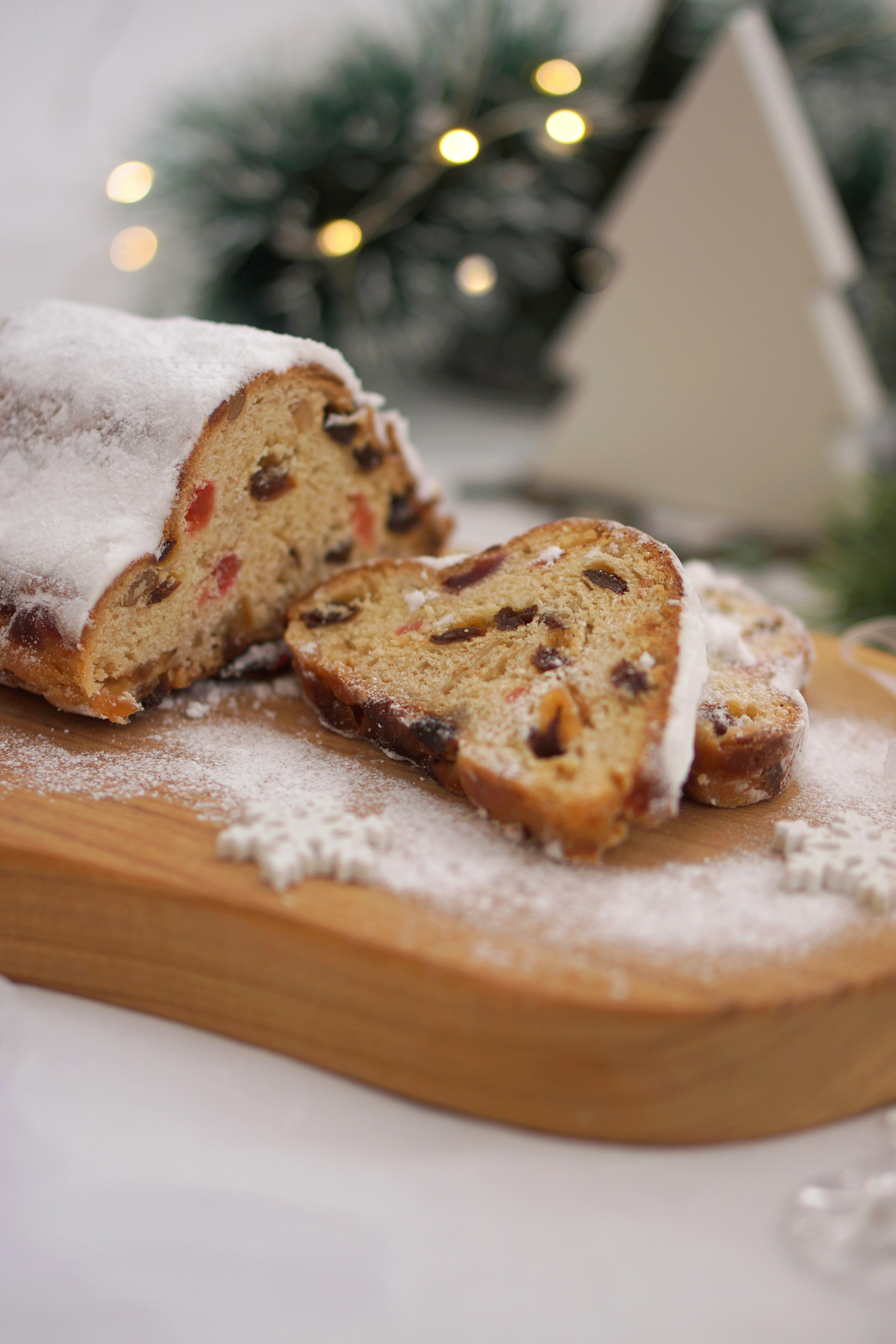 Christmas stollen on a wooden board dusted with powdered sugar