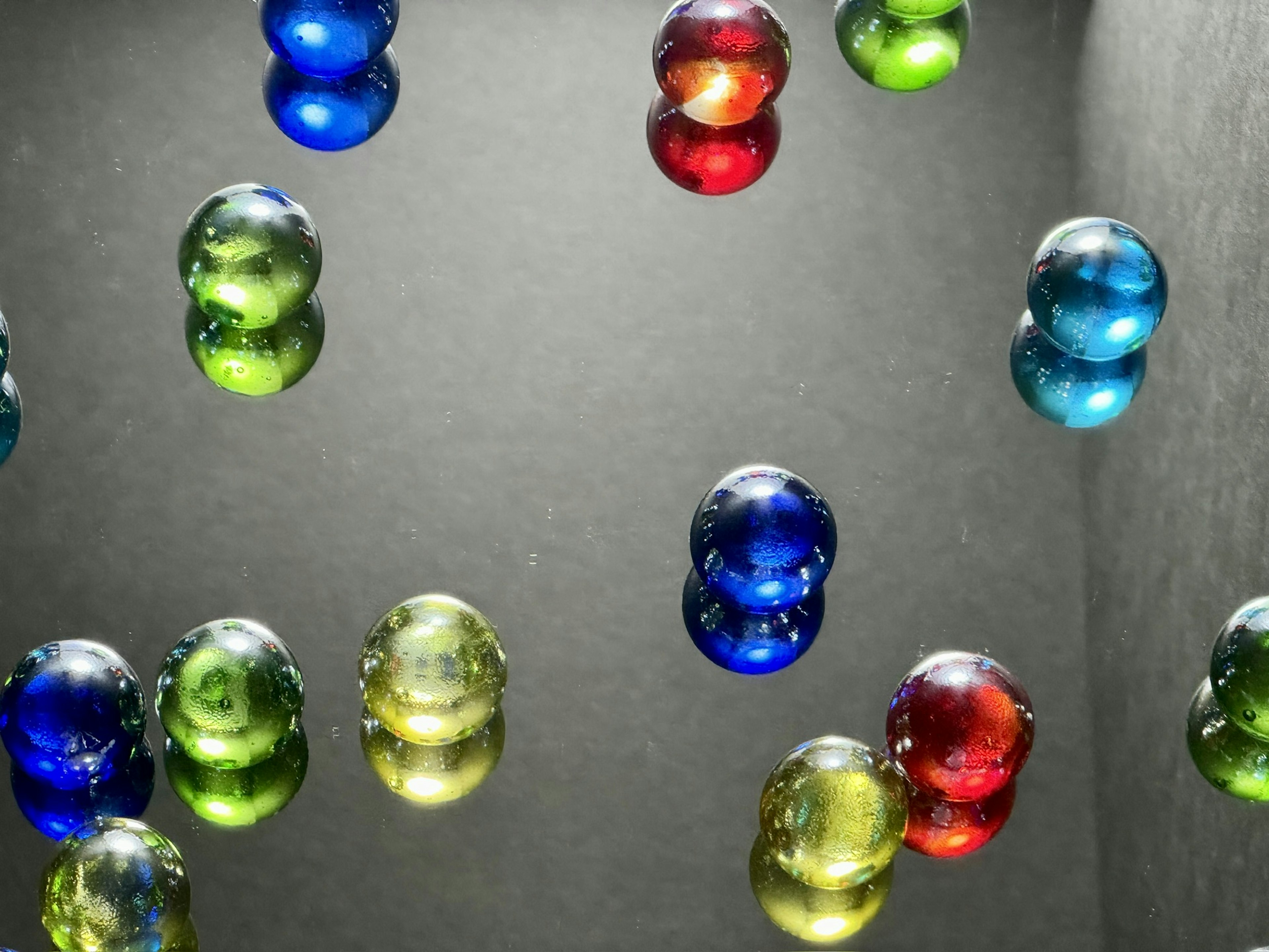 Colorful glass marbles floating in an abstract background