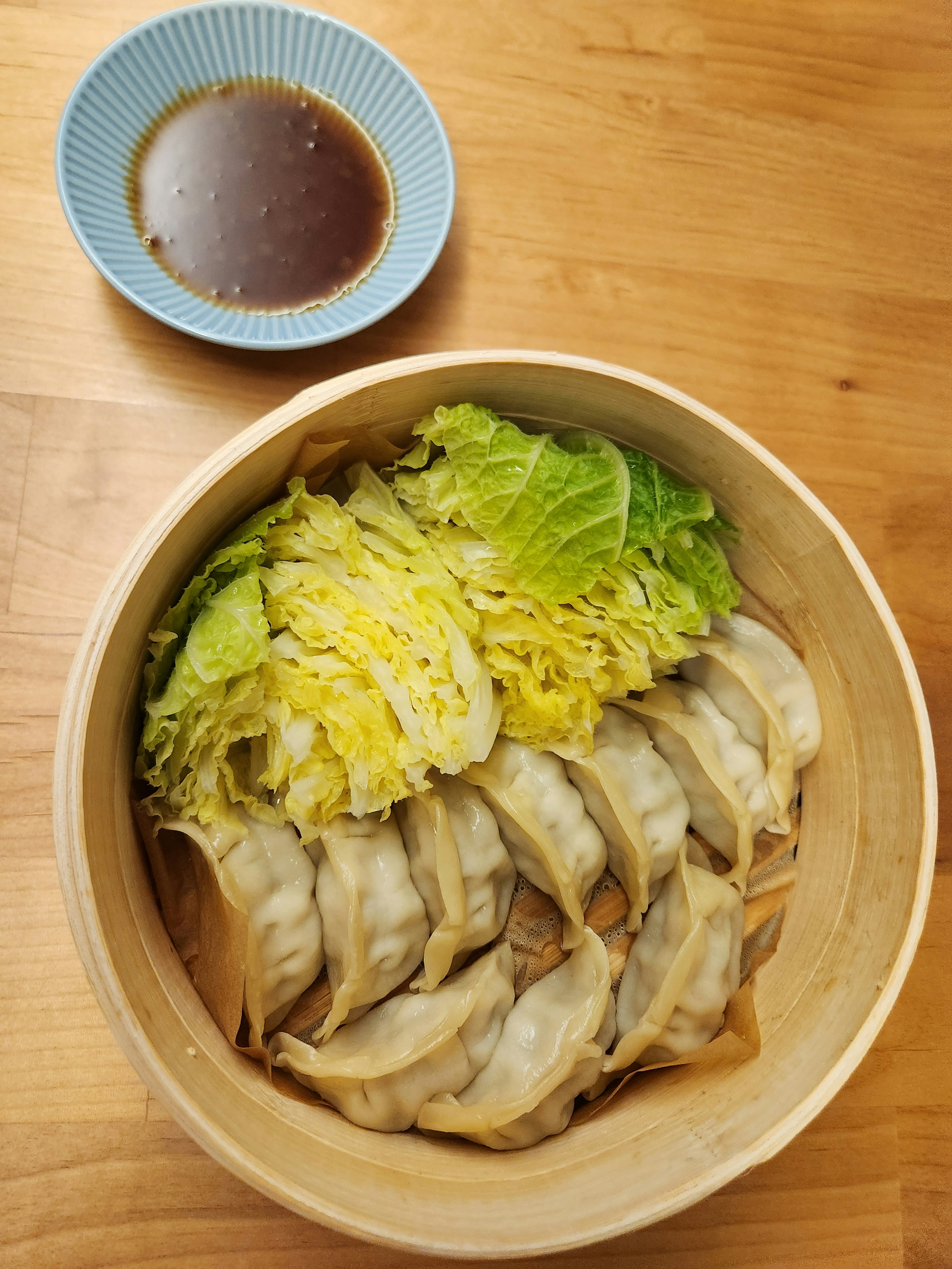 Plate of steamed dumplings with shredded cabbage