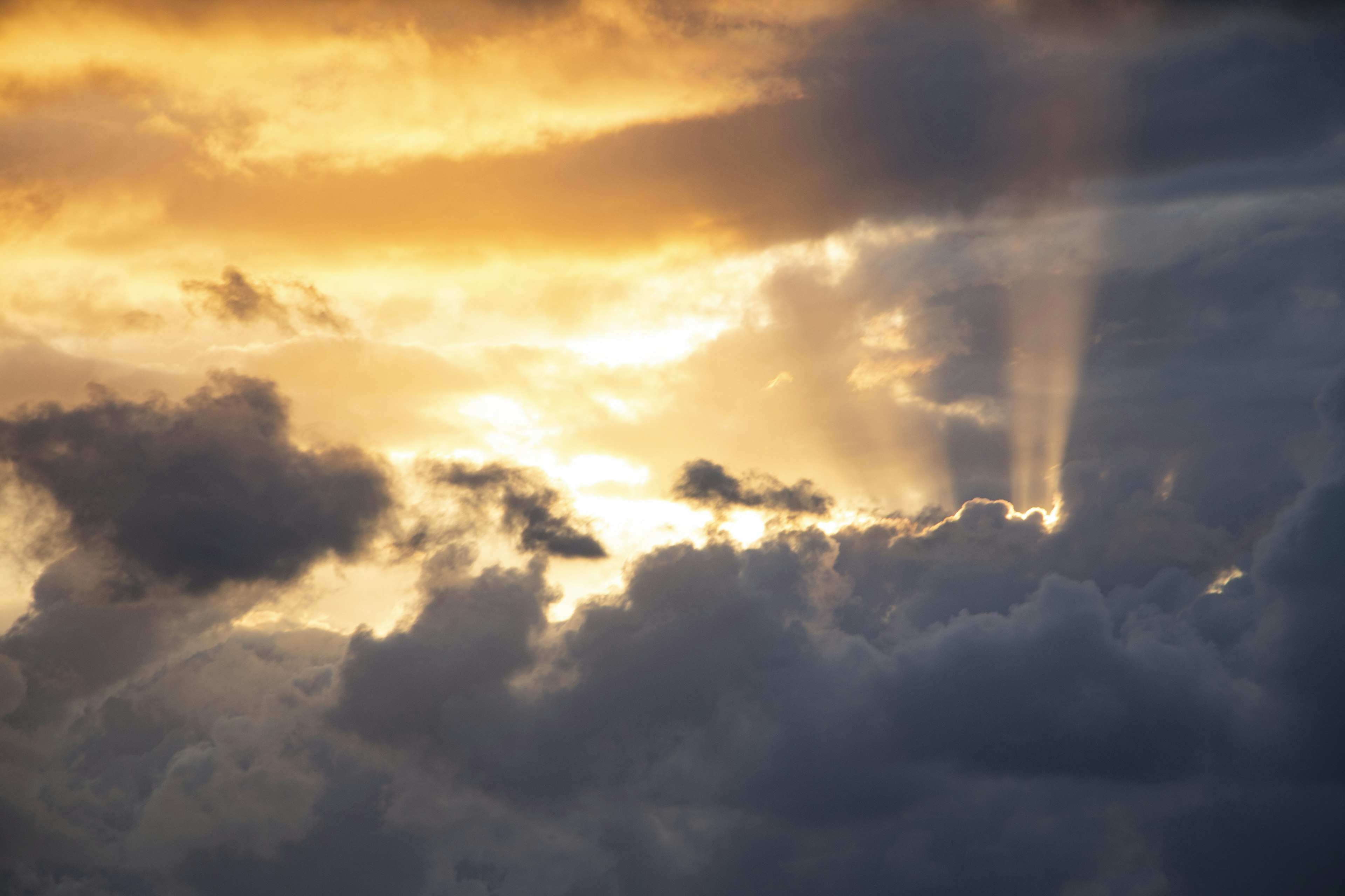 Beautiful landscape of golden sky with light shining through clouds