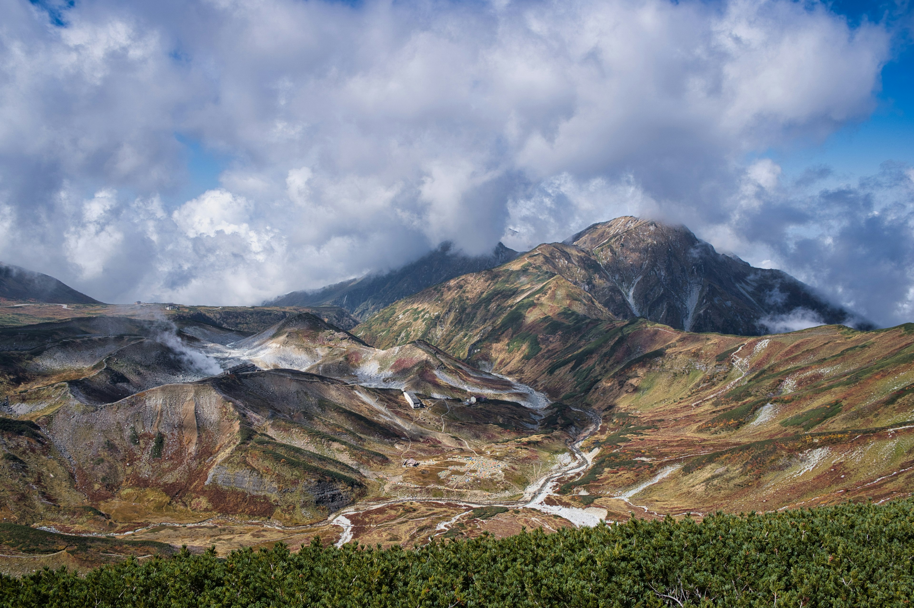 Vibrant mountain landscape with clouds and valleys