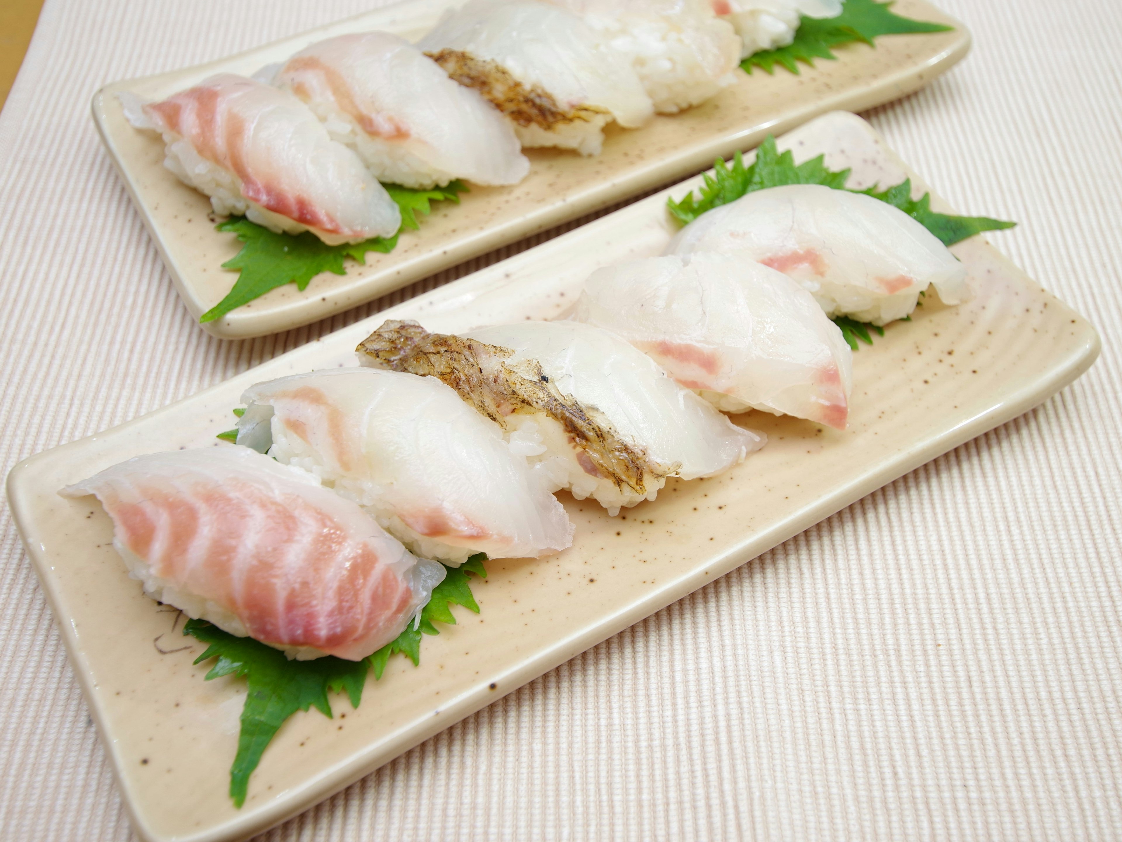 Plates of fresh sushi with various fish