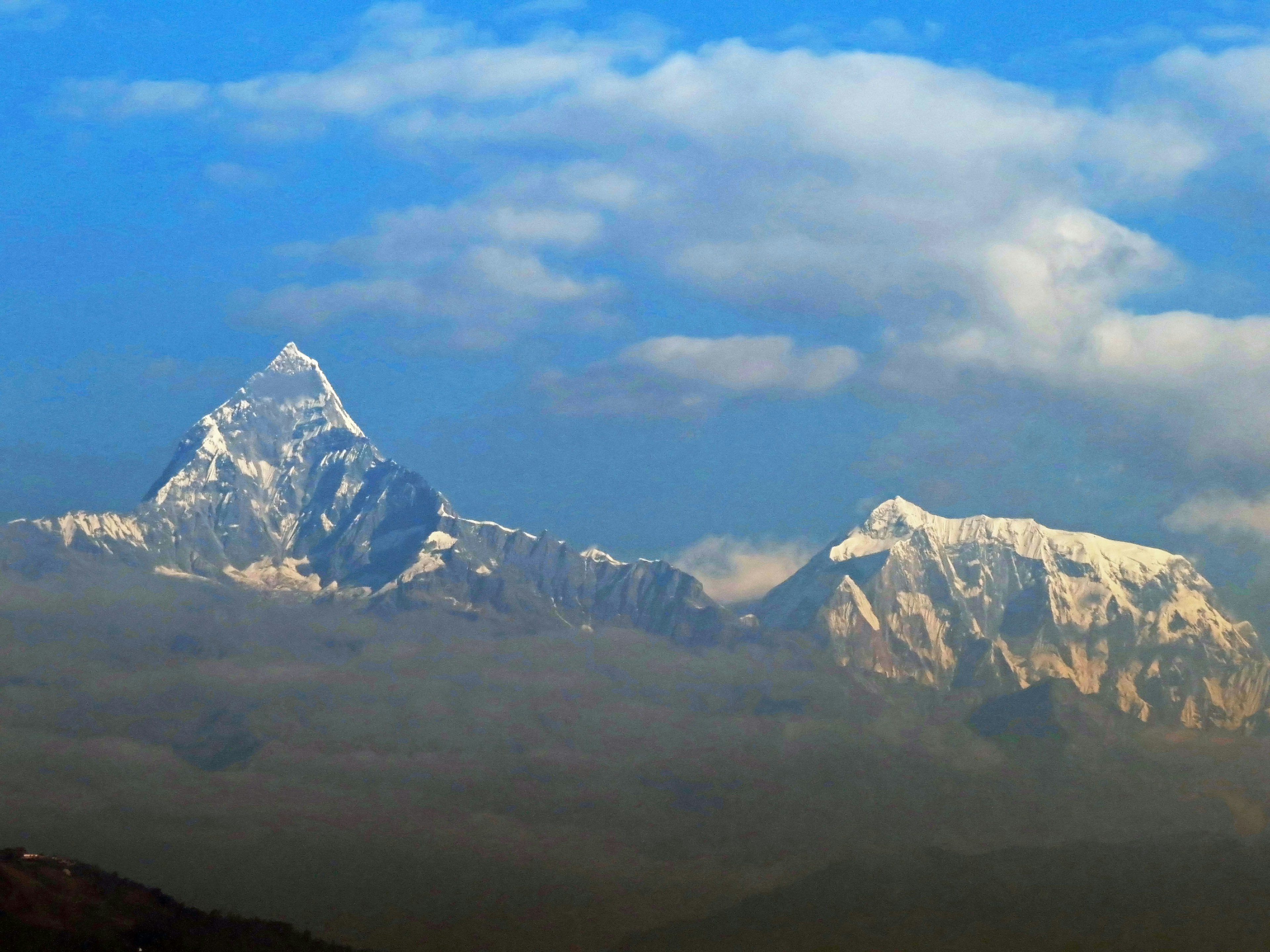 Snow-capped mountains under a blue sky