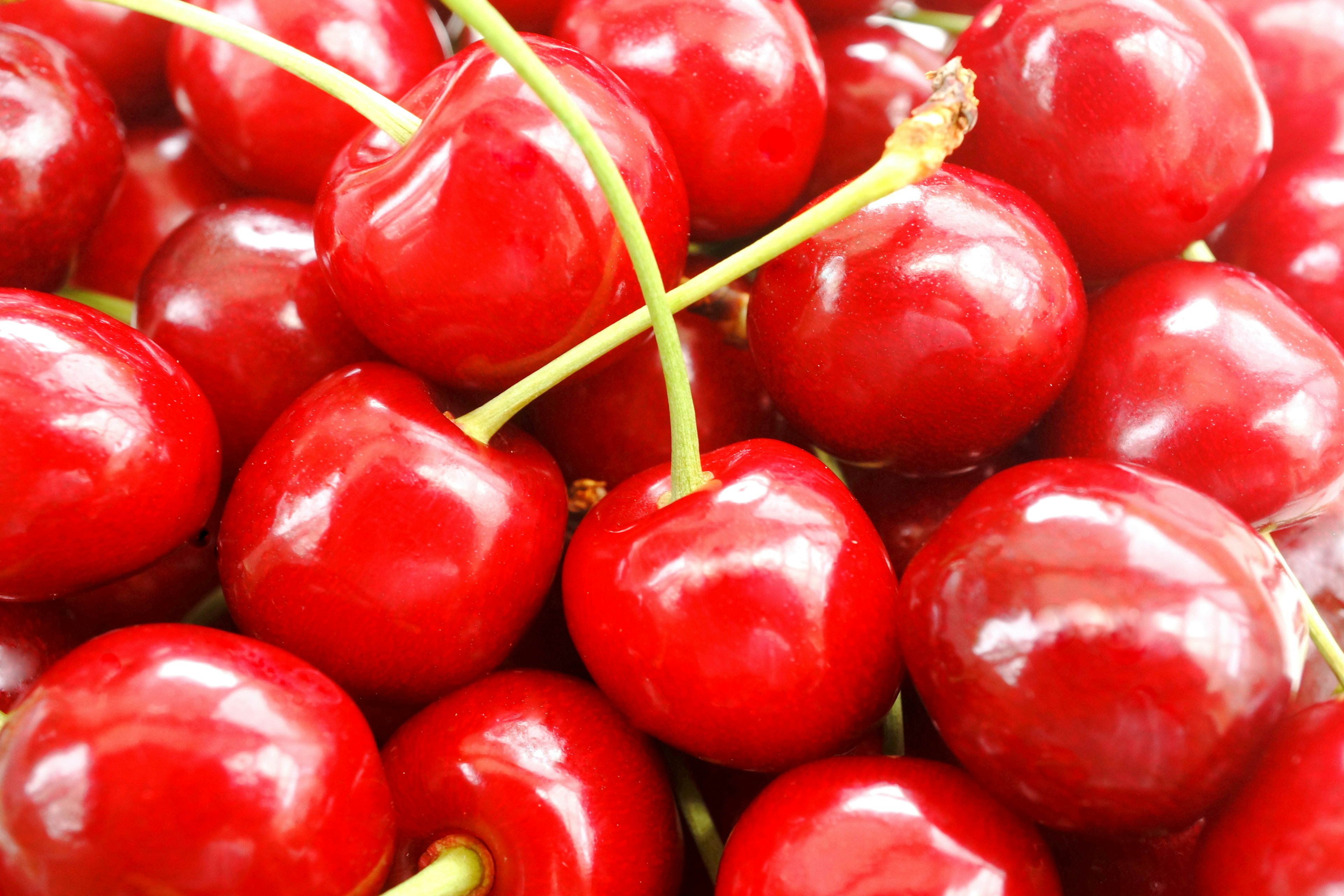 Vibrant red cherries clustered together