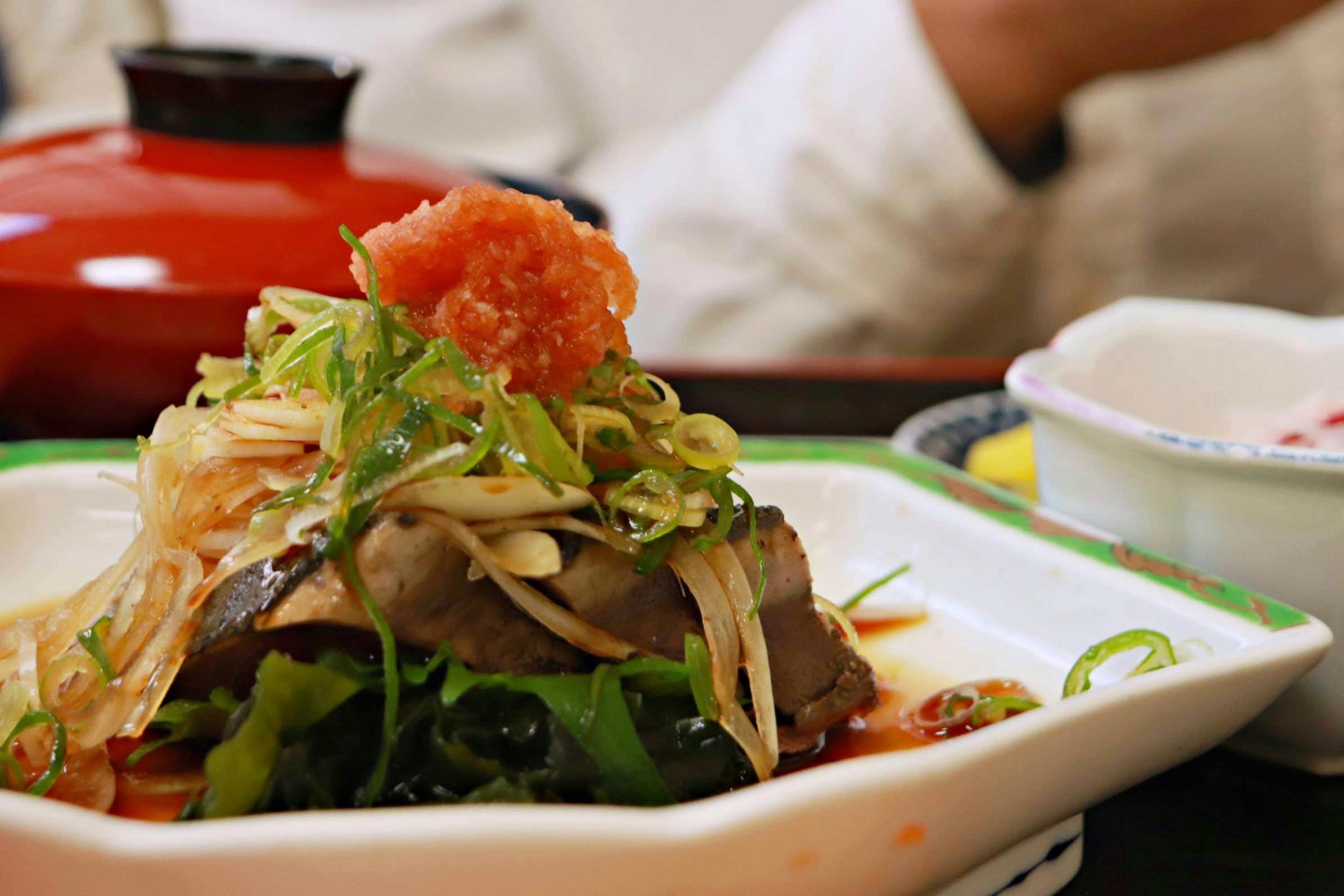 A vibrant presentation of Japanese cuisine featuring fresh fish and vegetables on a plate