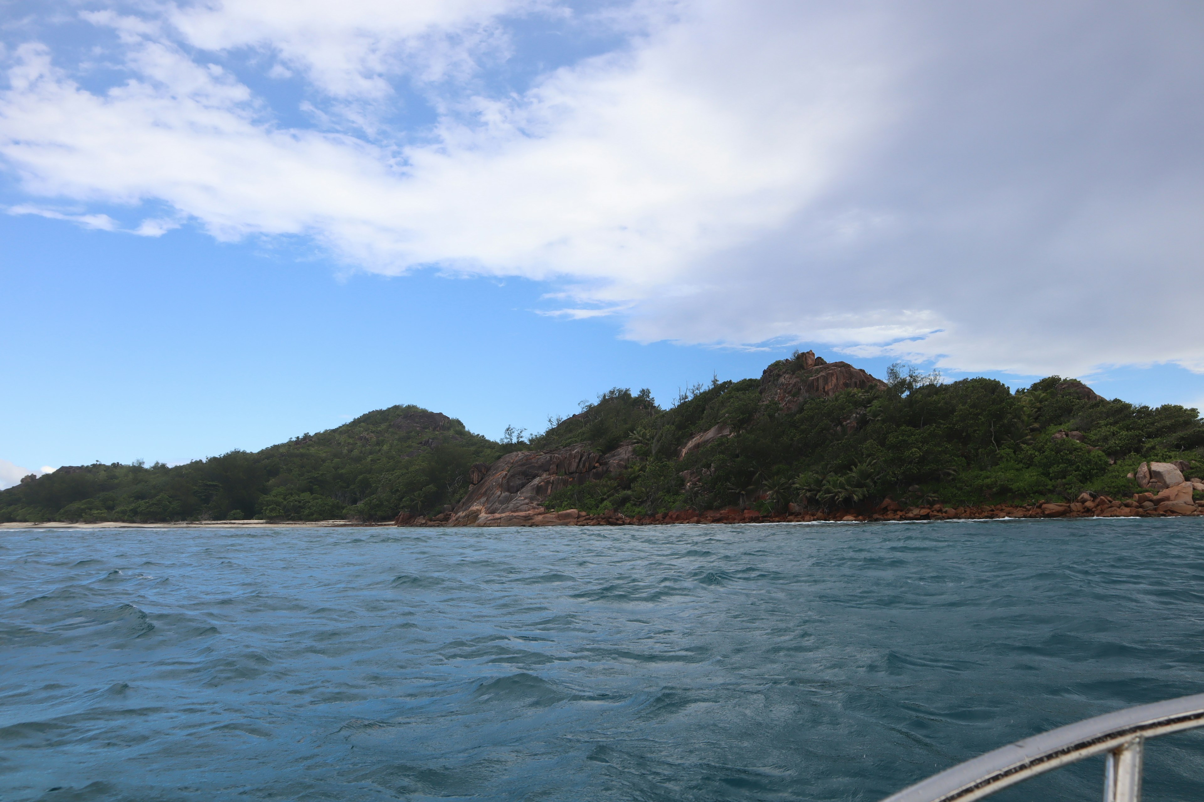 Scenic view of blue ocean and green hills