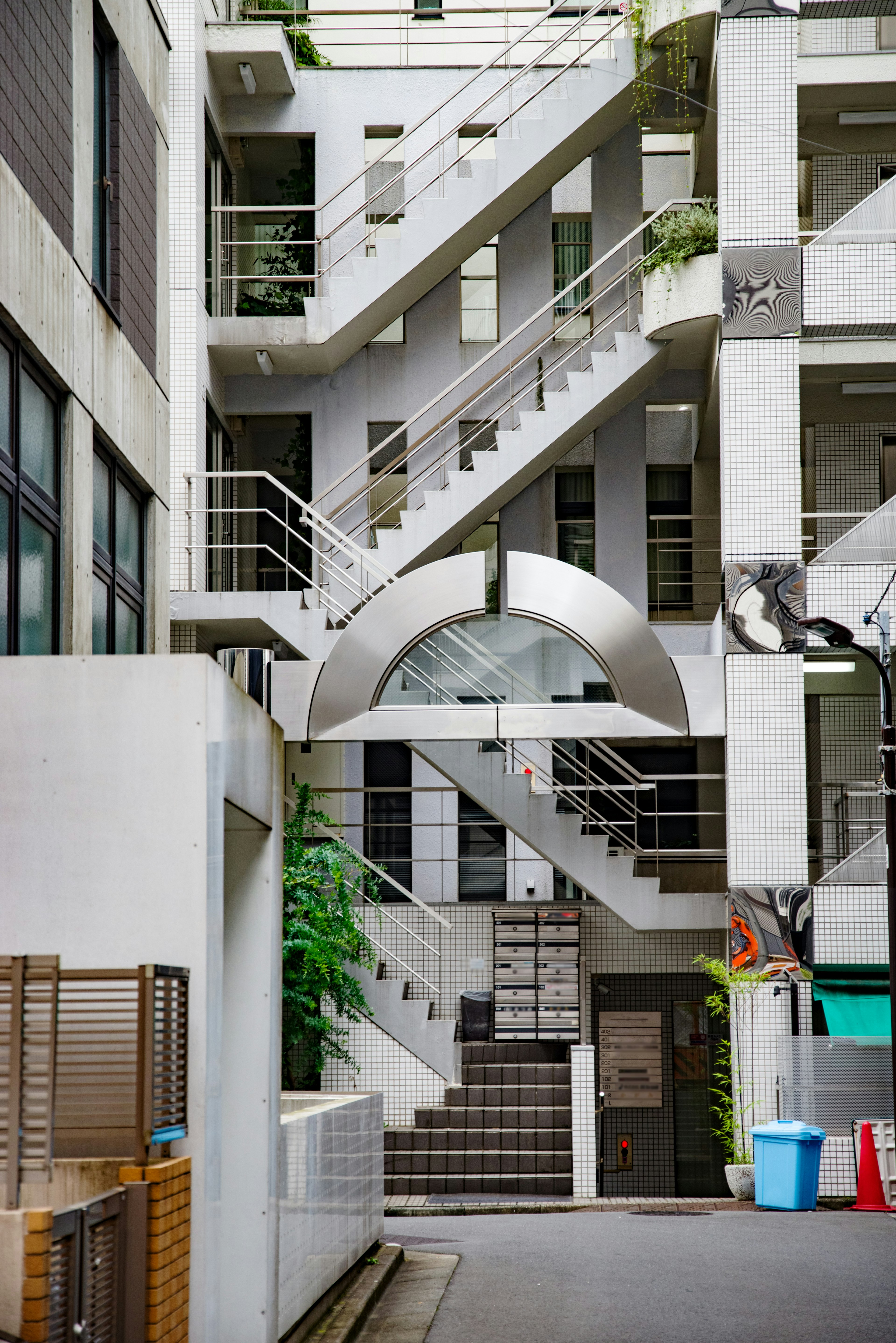 Scene featuring modern building interior with staircases and greenery