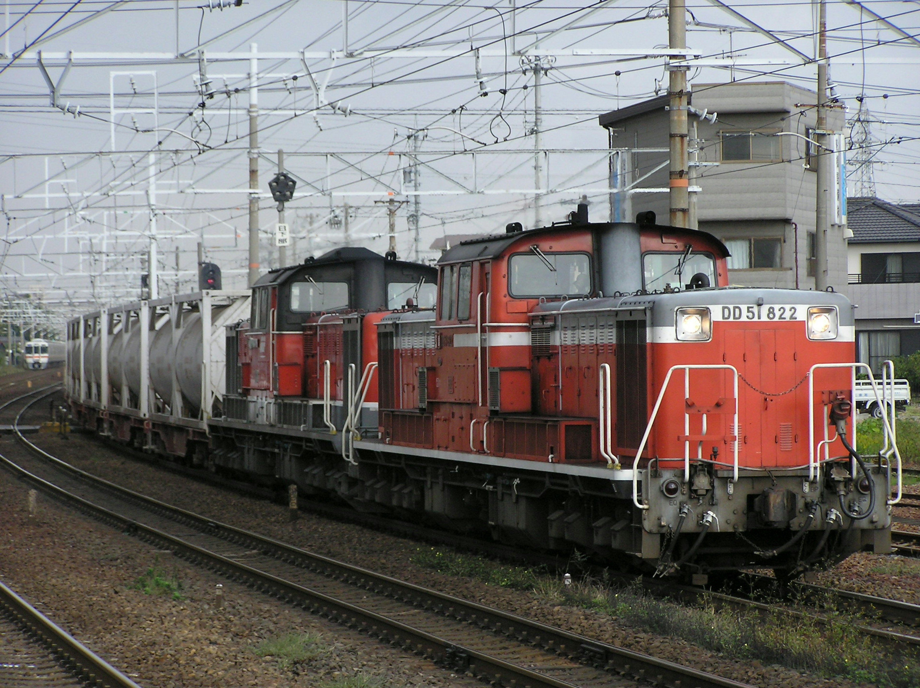 Red locomotives pulling a freight train on railway tracks