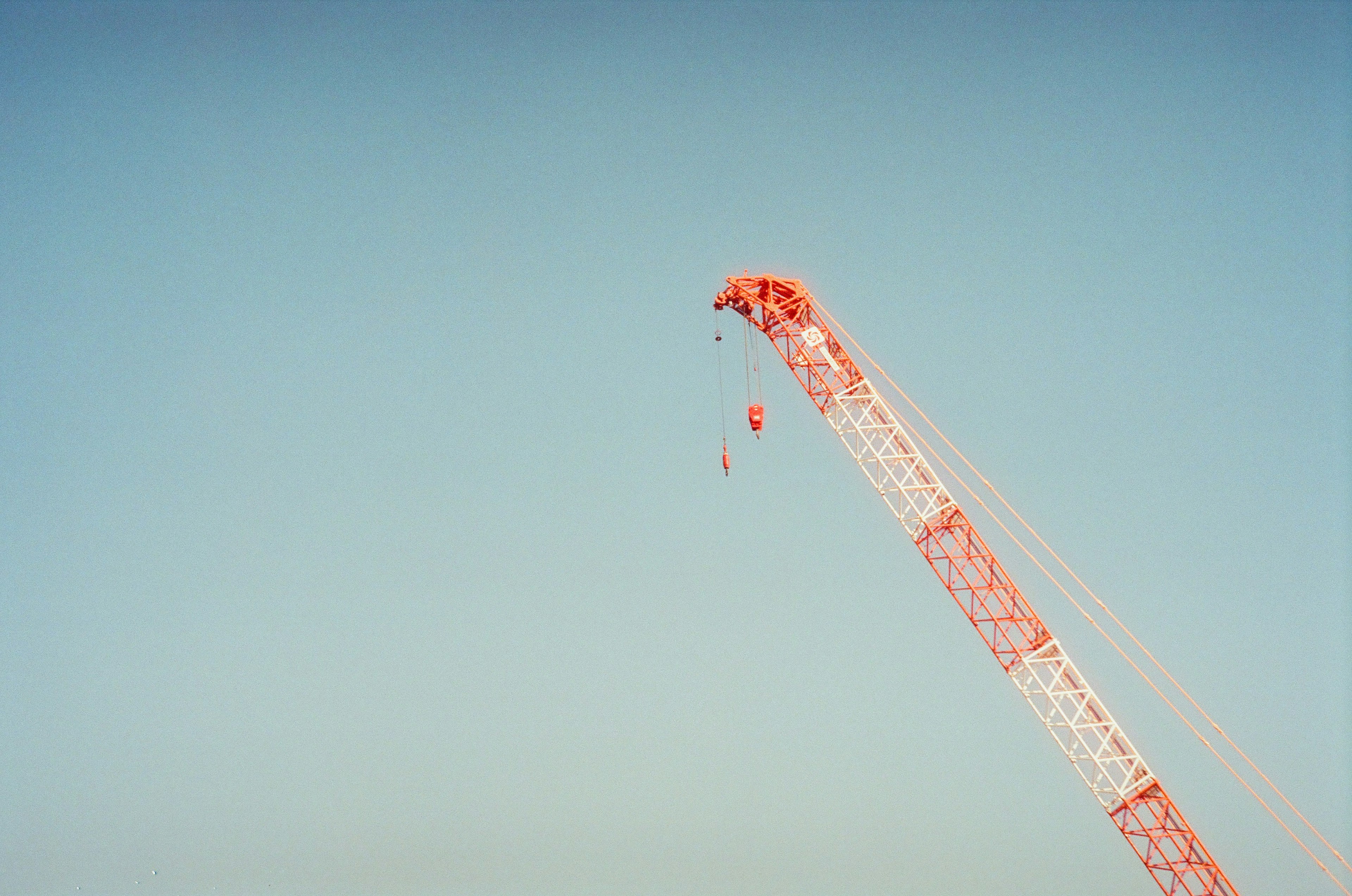 Red crane top against clear blue sky