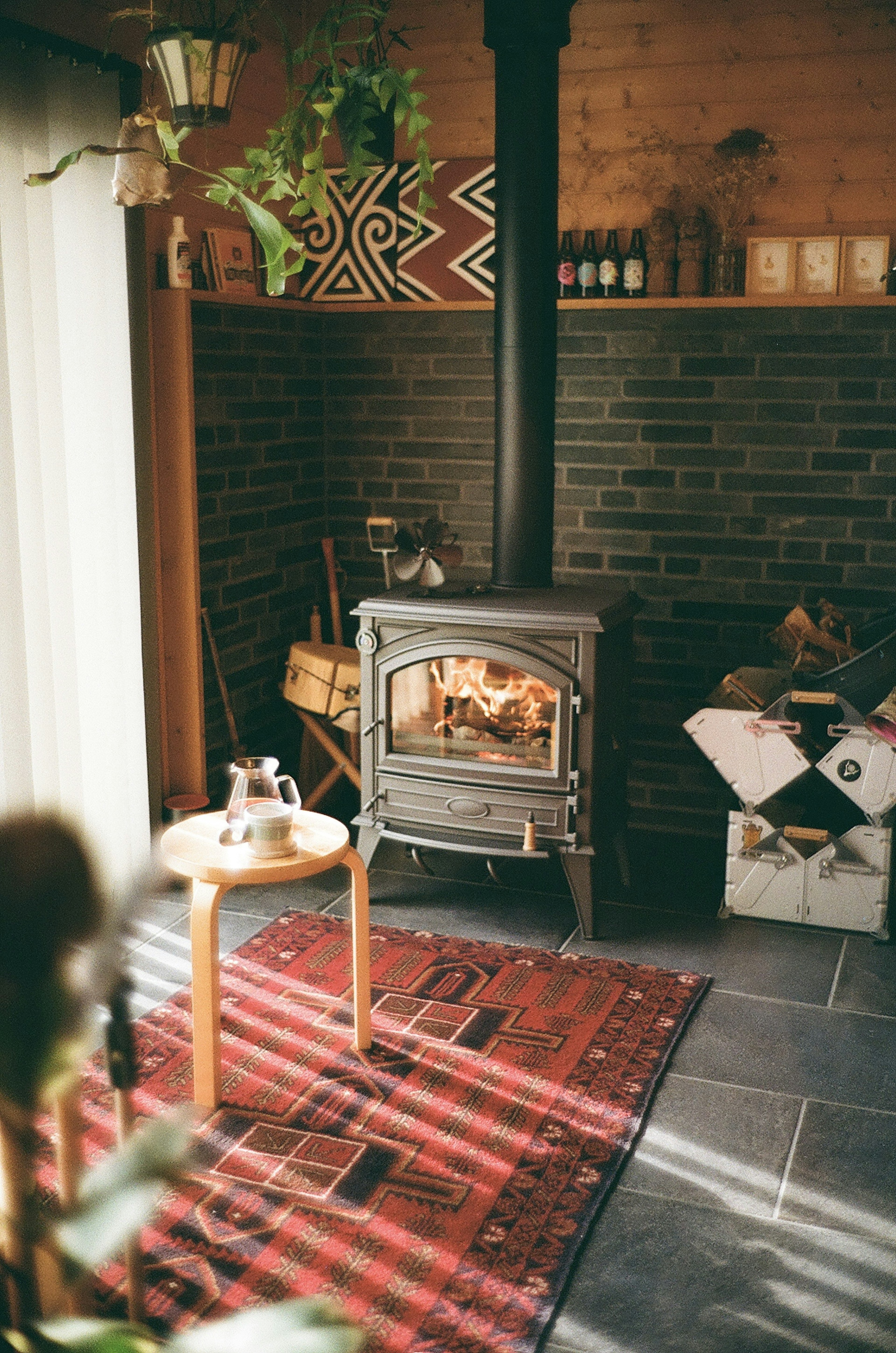 Cozy indoor space featuring a stove with warm lighting and decorative elements