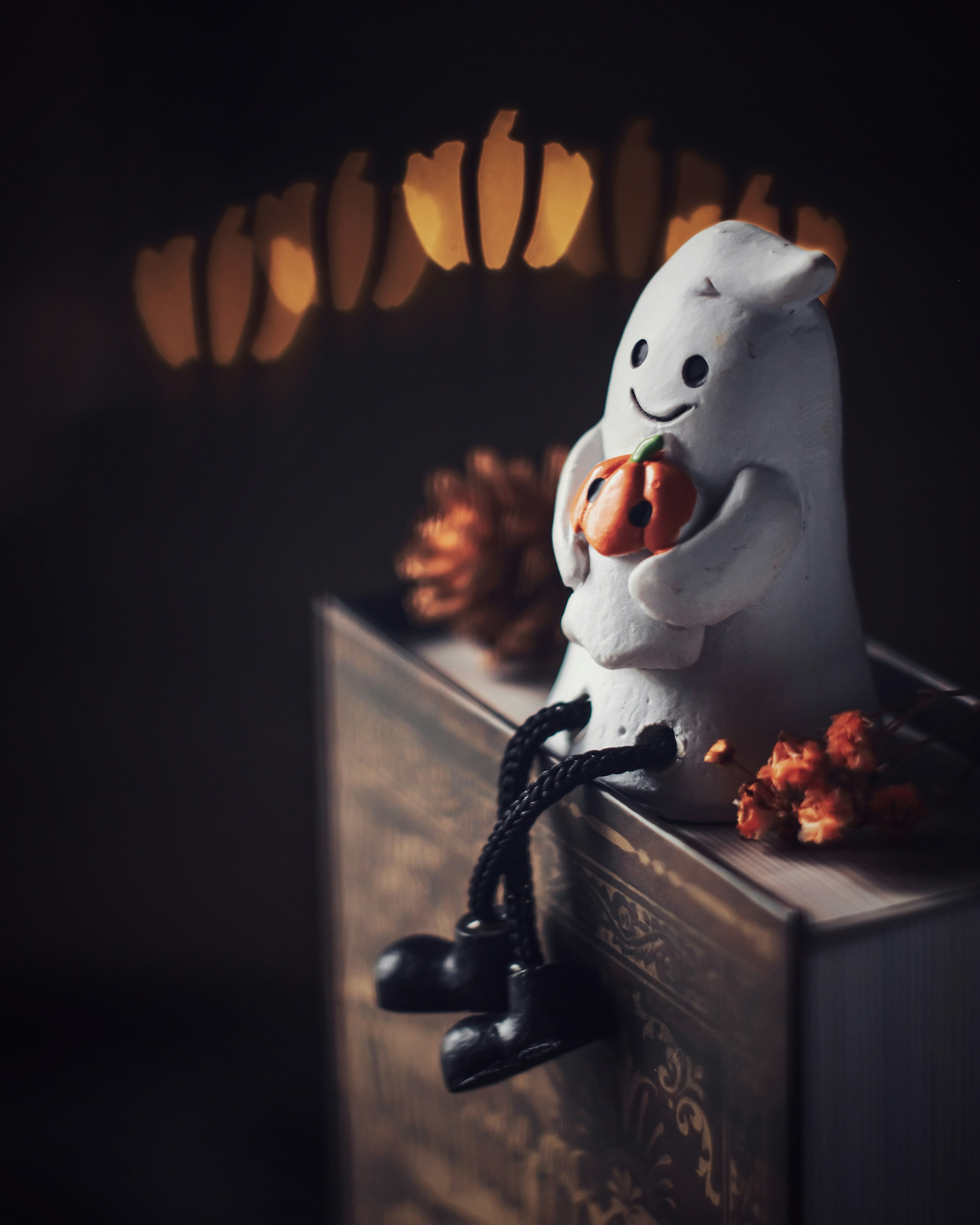 A white character holding orange fruits sitting on a book with soft background lights