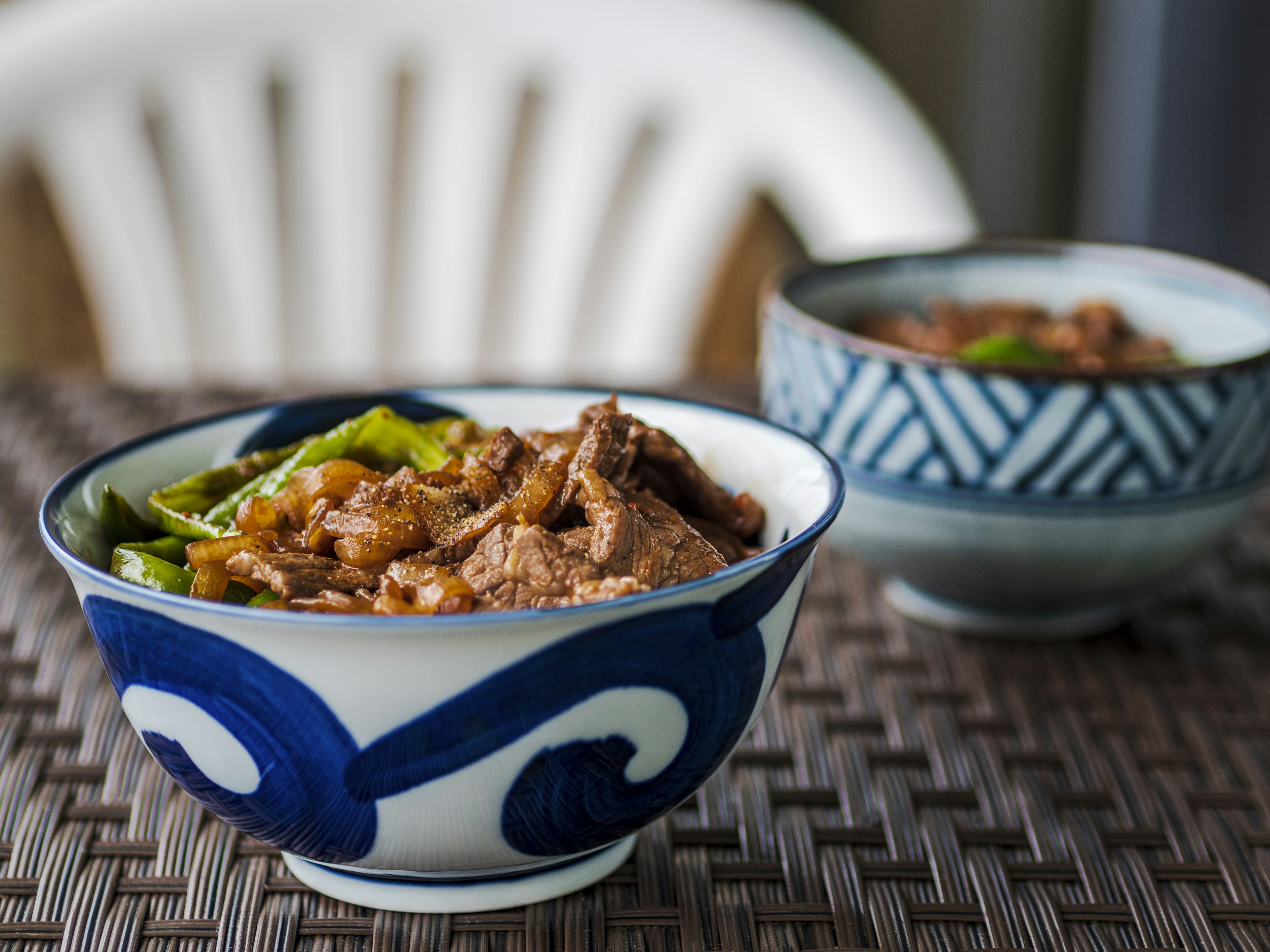 Dish of meat and vegetables in a blue patterned bowl