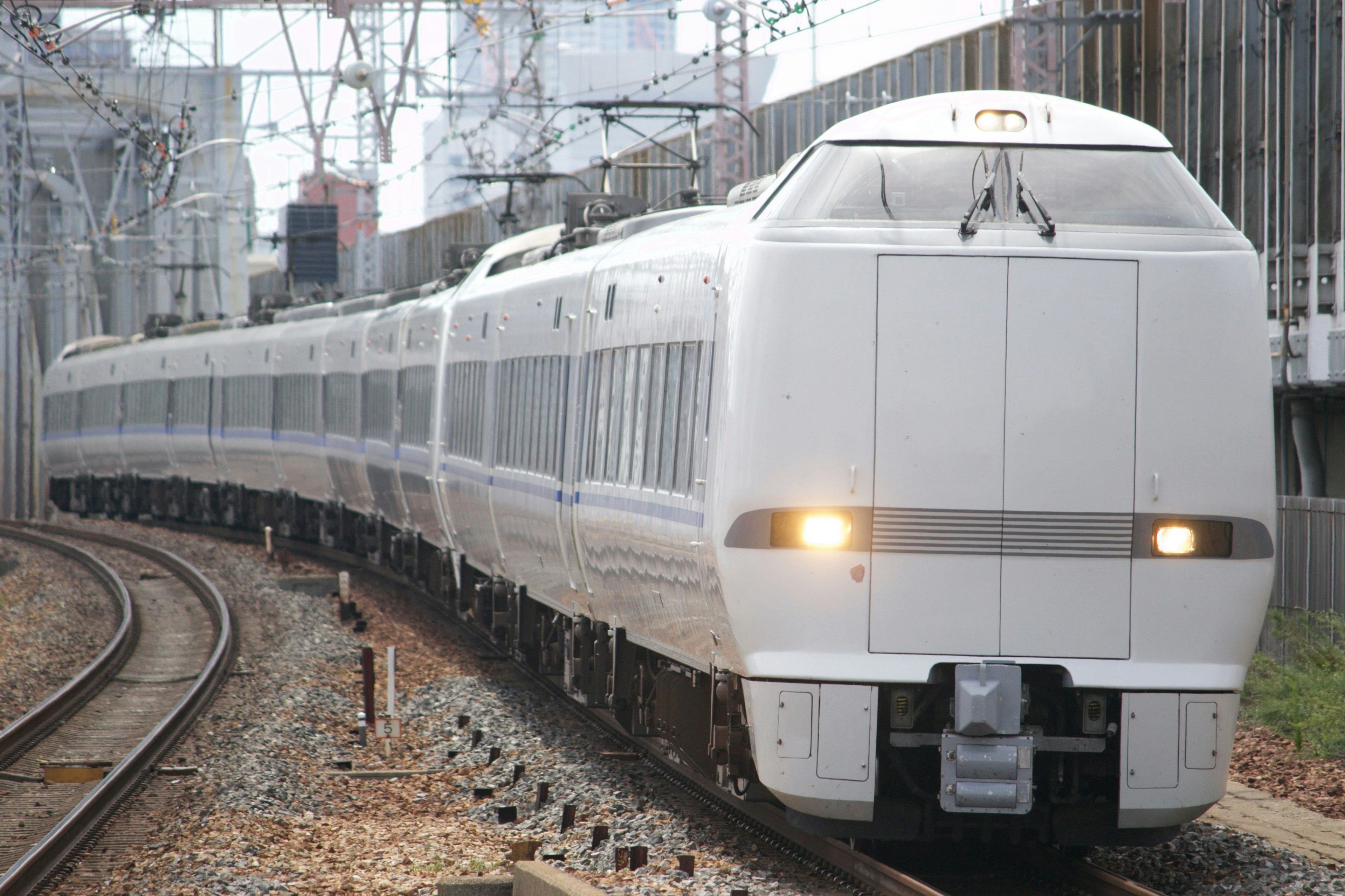 A white train curving along the tracks